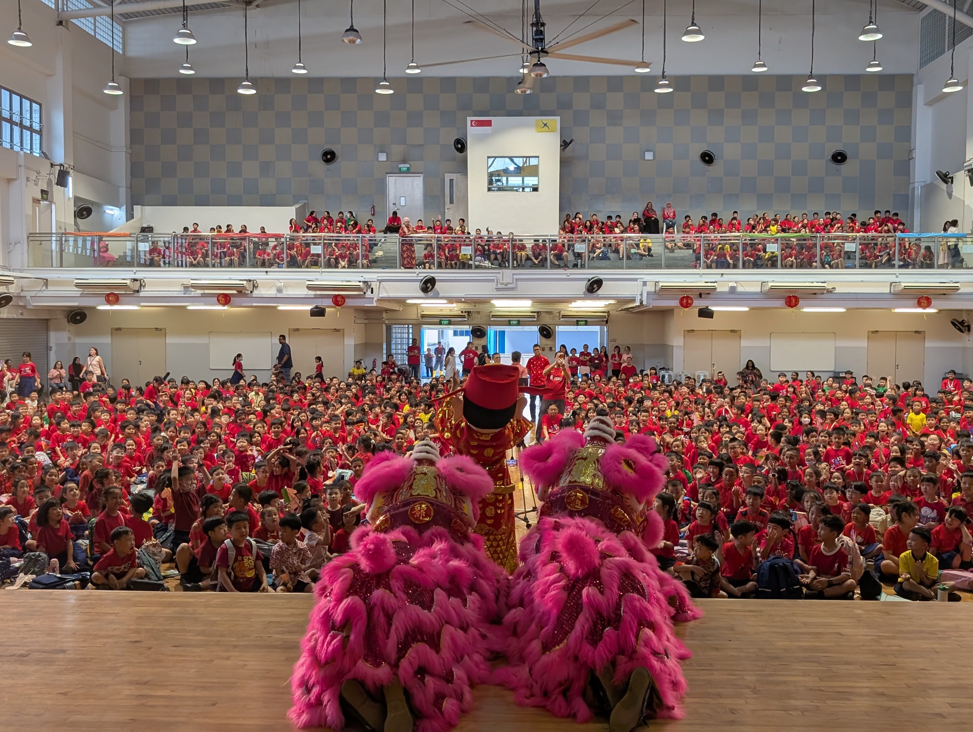 Lion dancers and performers on stage immersing the school in a festive celebration
