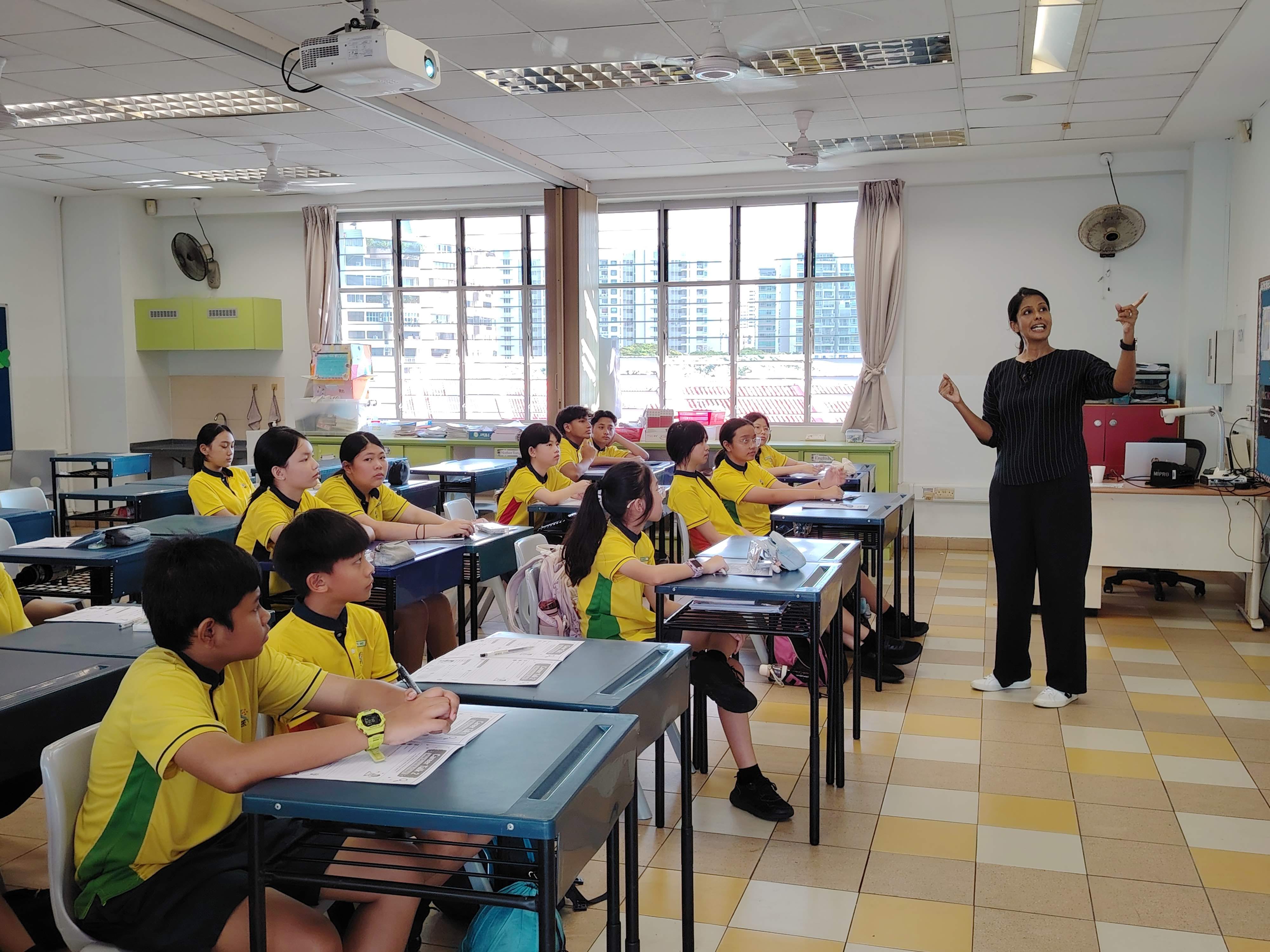 An Educational & Developmental Psychologist engages Primary 6 students in an interactive career talk as students listen attentively and ask questions.