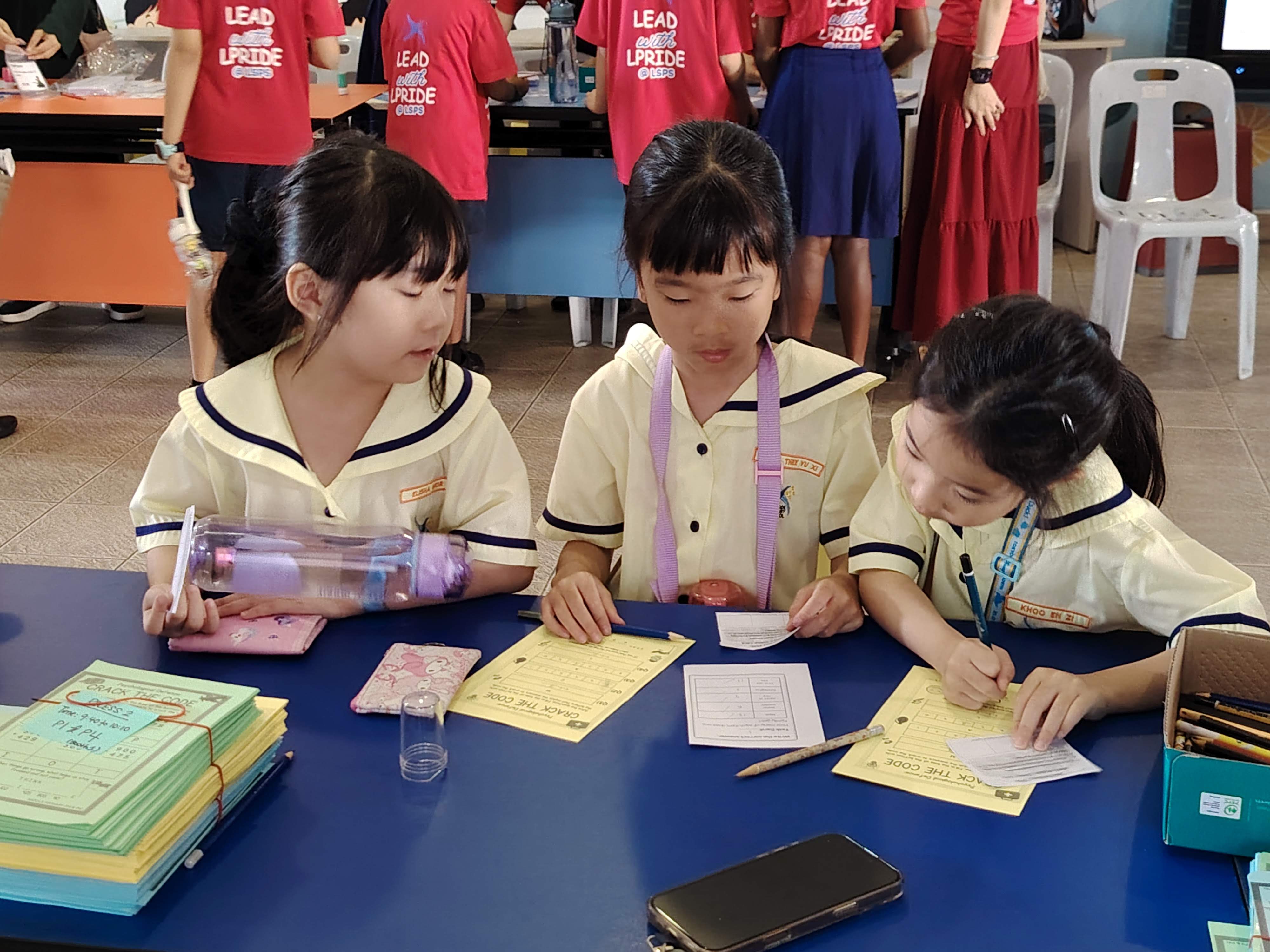 Three students work together to solve maths questions to try and crack the code