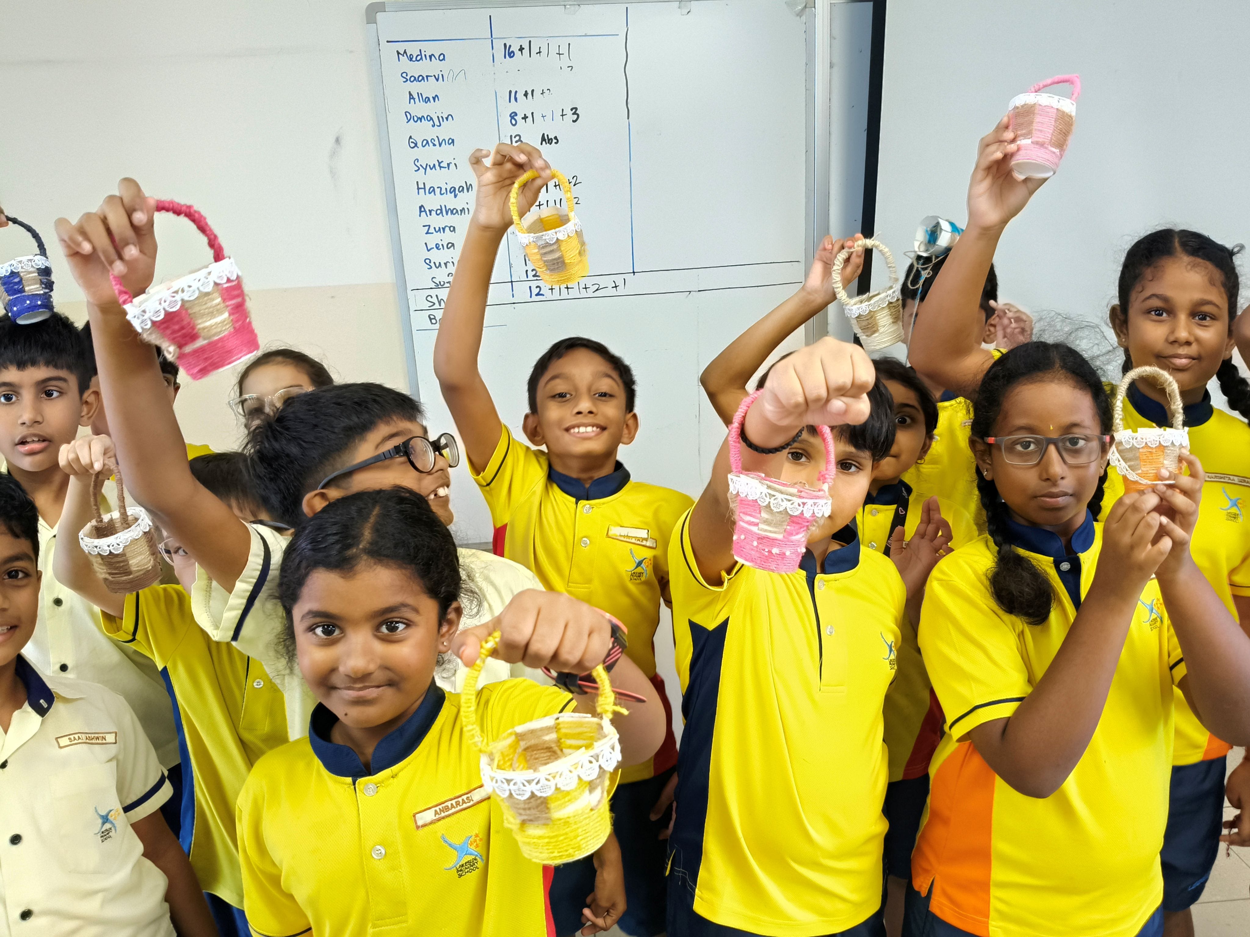 Our P3 Tamil students pose for a group photo with their own traditionally weaved basket