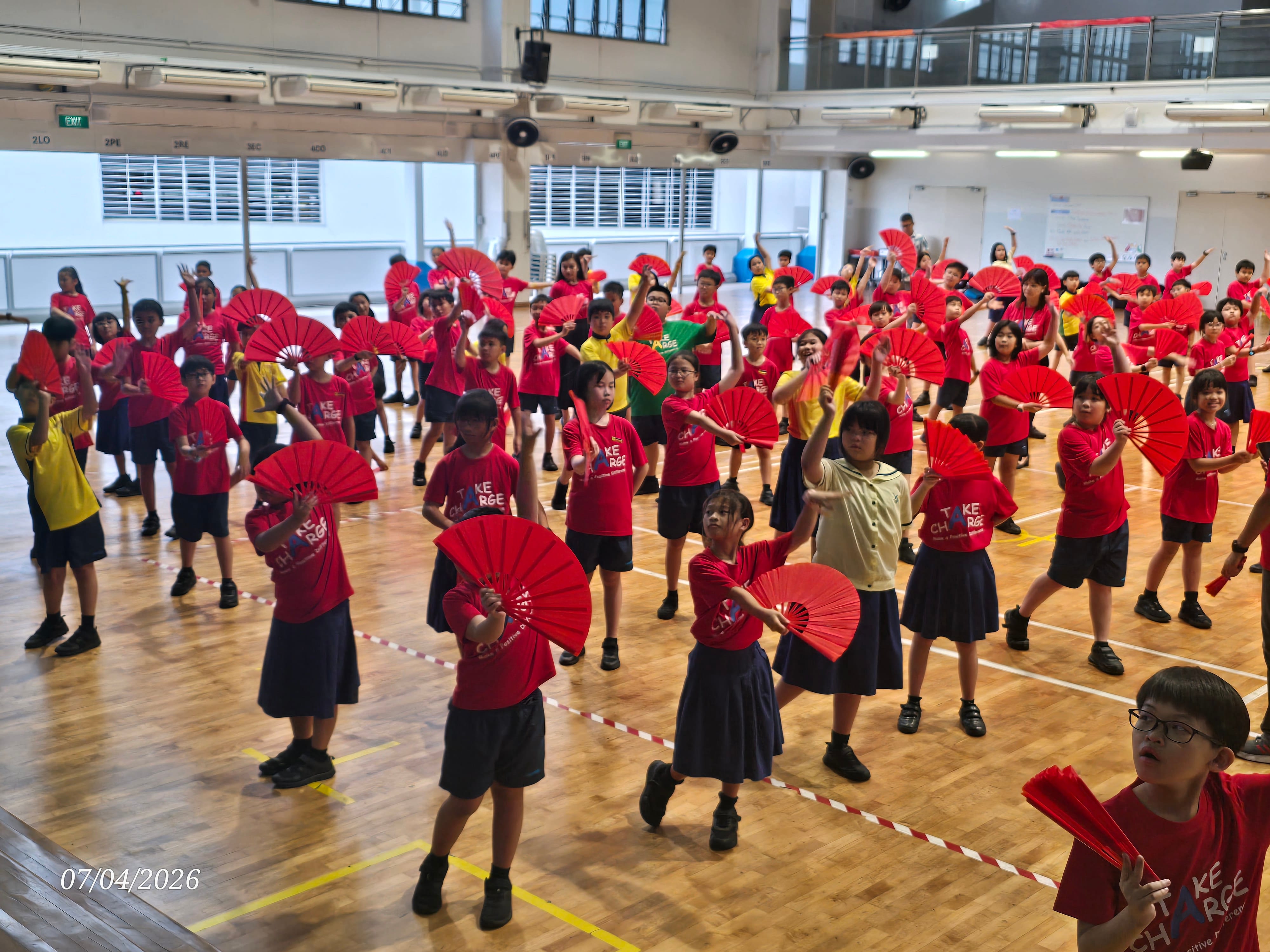 P4 students gathered in the hall as they learn traditional Chinese fan dancing
