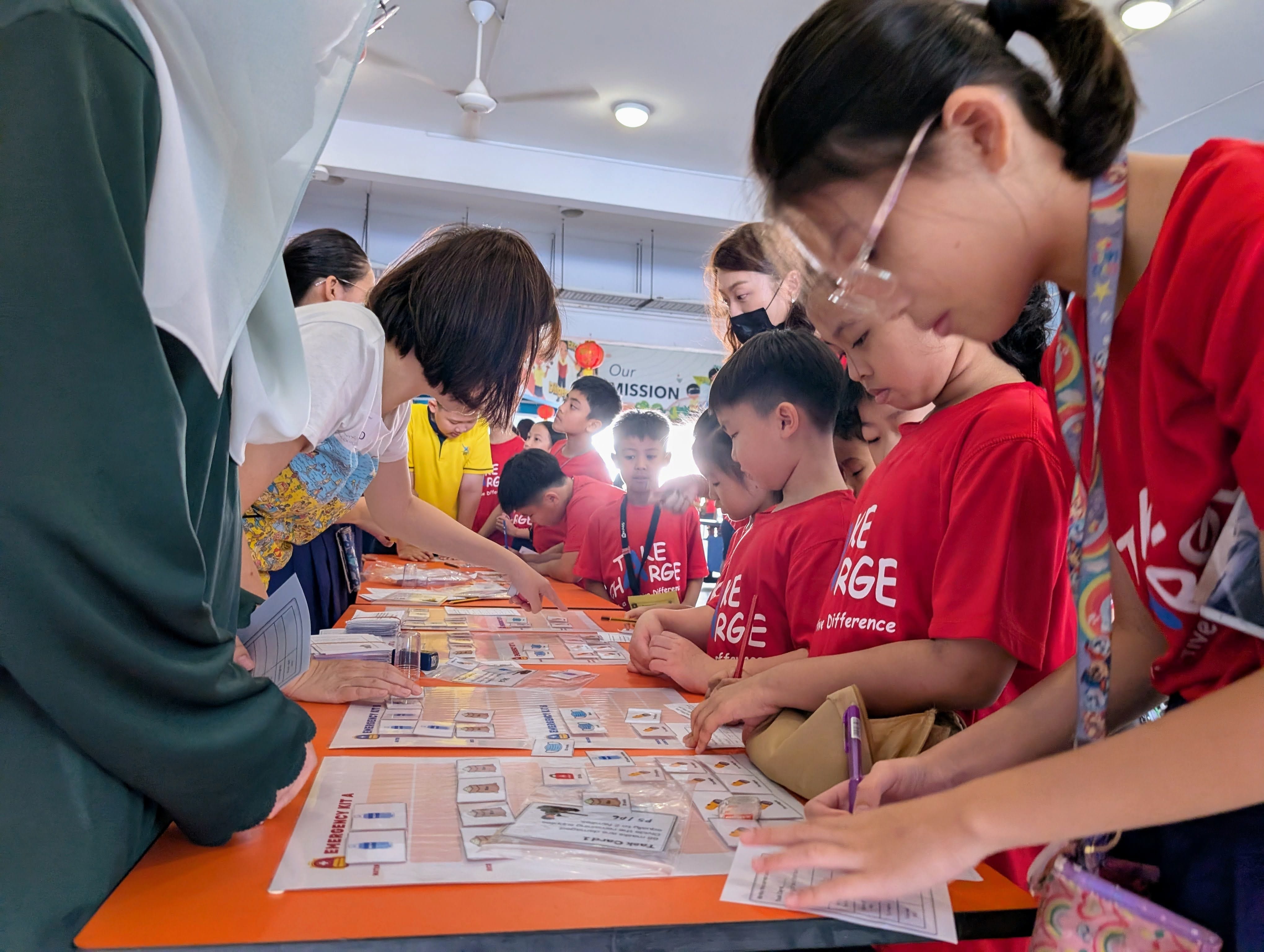 Students using mathematical skills to help them play the role of a defence planner at one of the activity booths