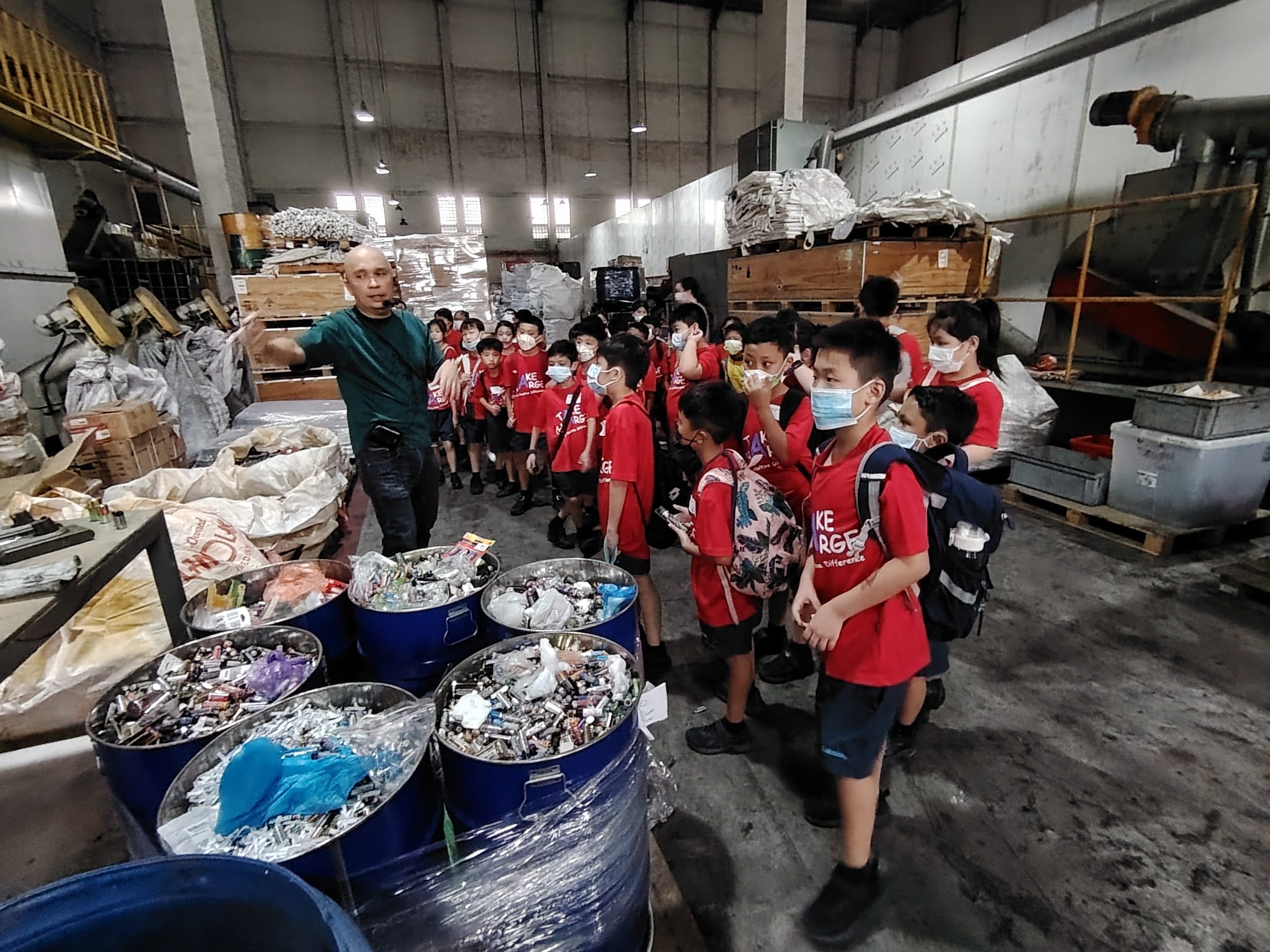 Students learning about waste management and the importance of reducing, reusing, and recycling.