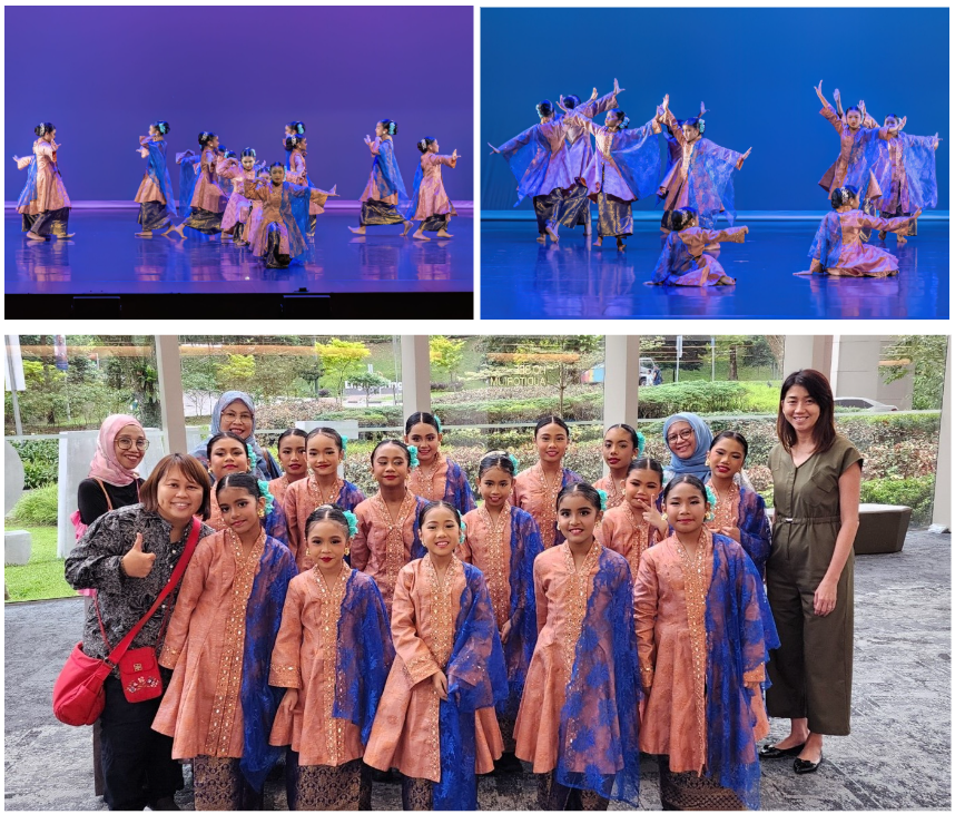 Girls in pink and blue traditional costumes perform on a blue-lit stage, and pose for a group photo after.
