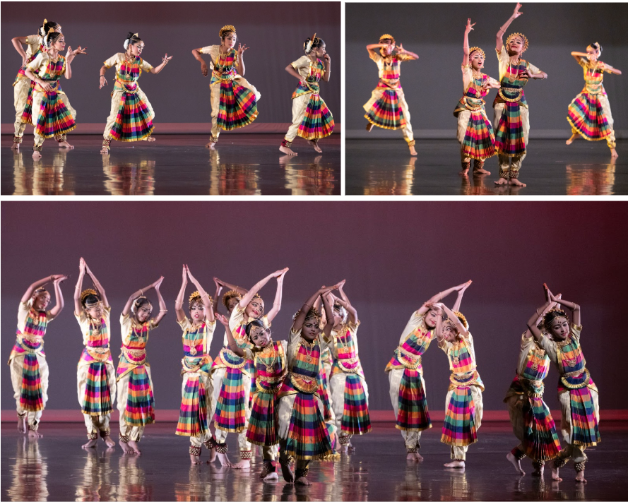 Dancers in colorful striped skirts and gold accessories perform classical Indian dance on a stage.