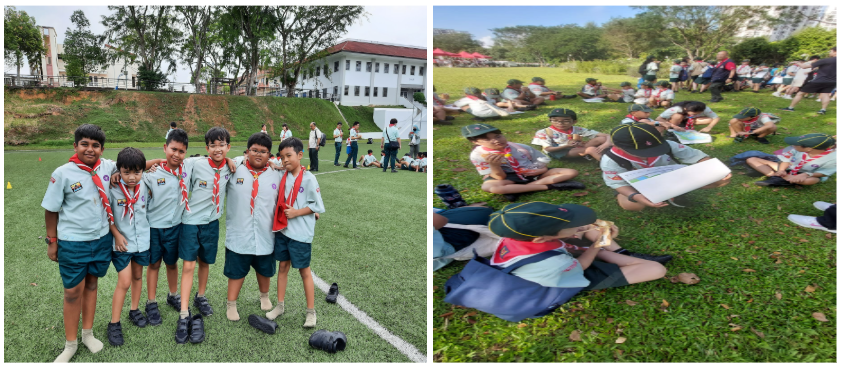 Six young scouts in uniform pose on a field; nearby, more scouts sit on grass with papers at an outdoor event.