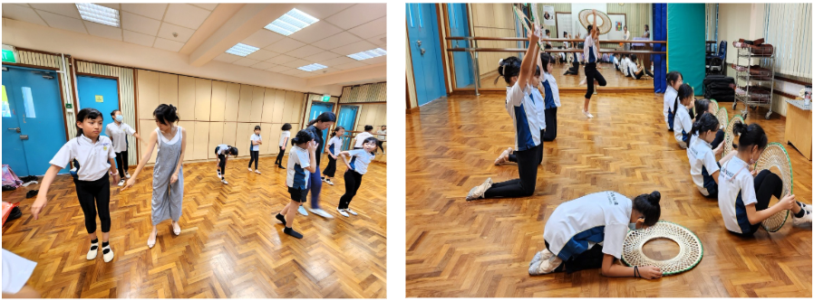 Children practice dance moves in two studio rooms with wooden floors, some holding hoops and props.