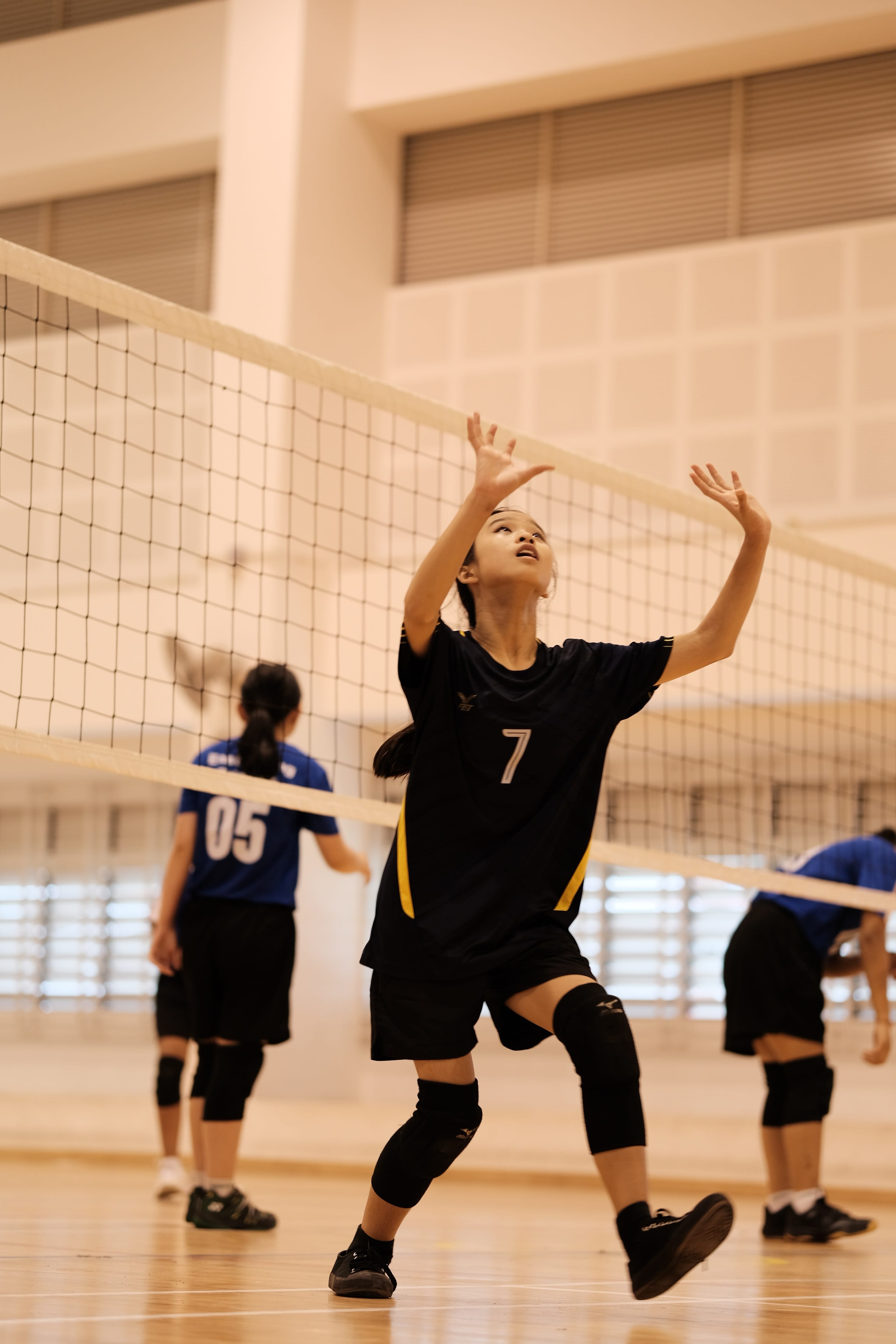 A girl trying to catch a volleyball