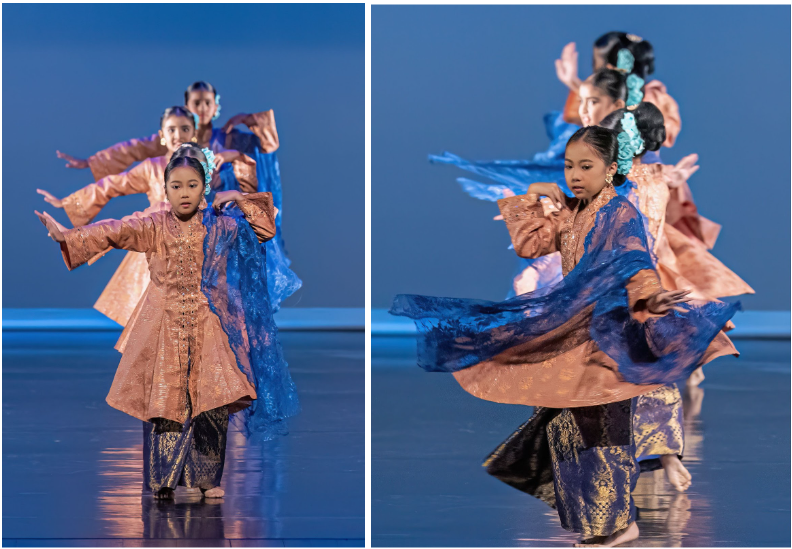 Young girls perform a traditional Southeast Asian dance on stage, wearing copper and blue costumes with flowing fabric.