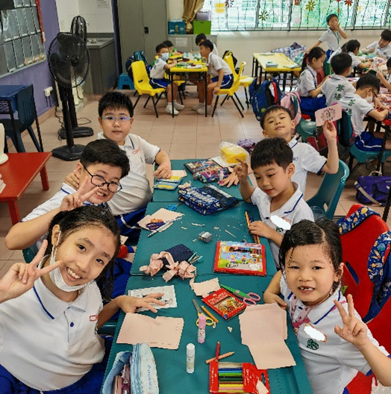 Seniors supporting their juniors to make Chinese New Year craft work.