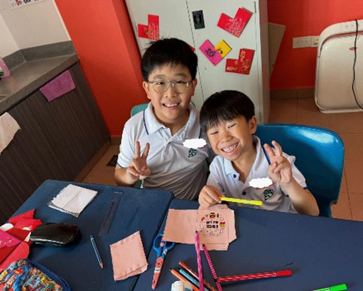Seniors supporting their juniors to make Chinese New Year craft work.
