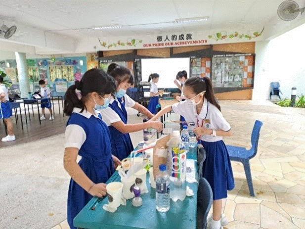 Students in school uniform preparing their game booth during Well-Being Week (Cyber Wellness)