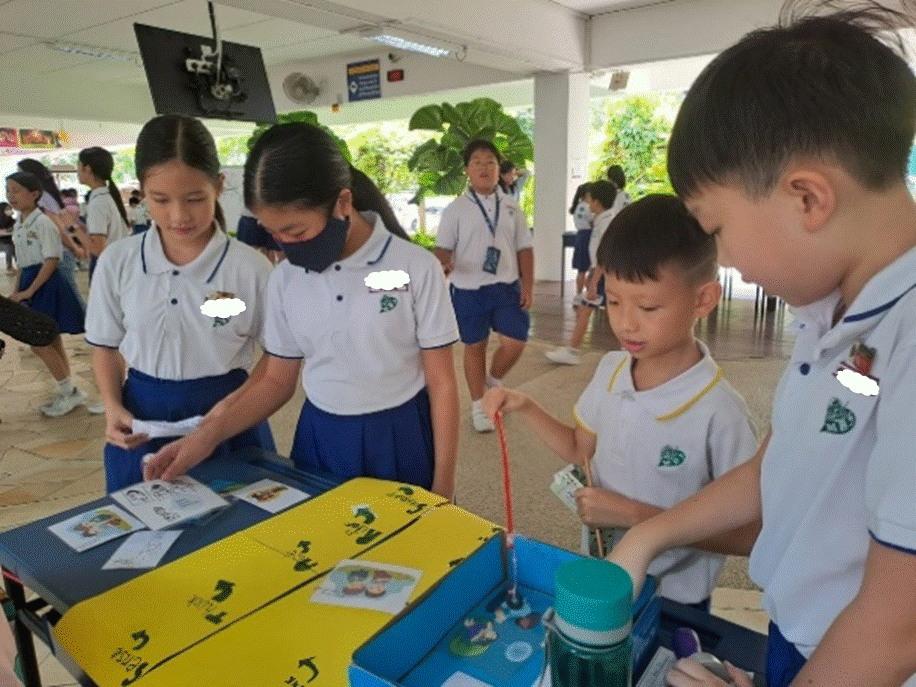 Students in school uniform preparing their game booth during Well-Being Week (Cyber Wellness)