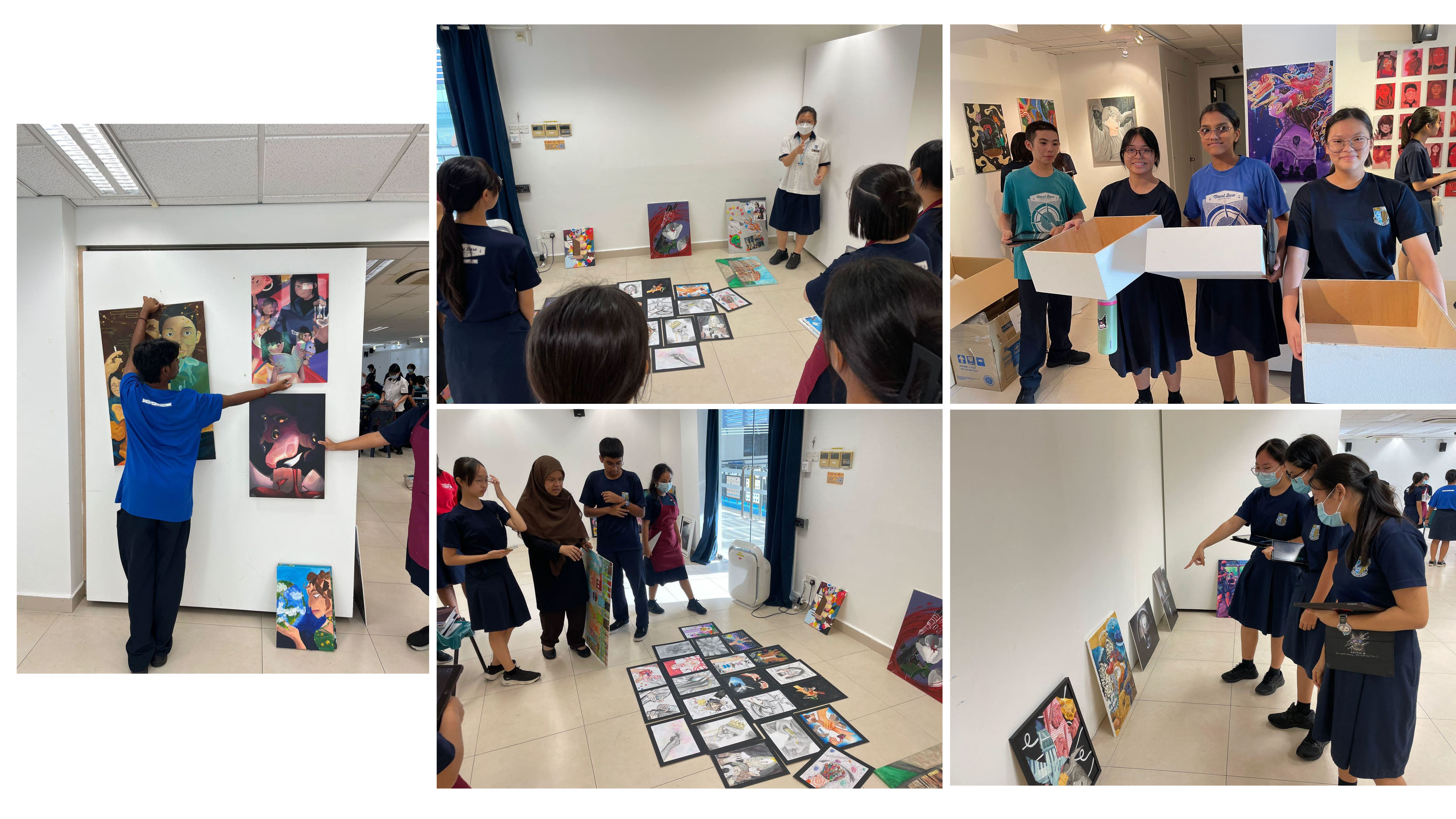 Students in school uniforms arrange and display colorful artwork on walls and floors during an art exhibition setup.
