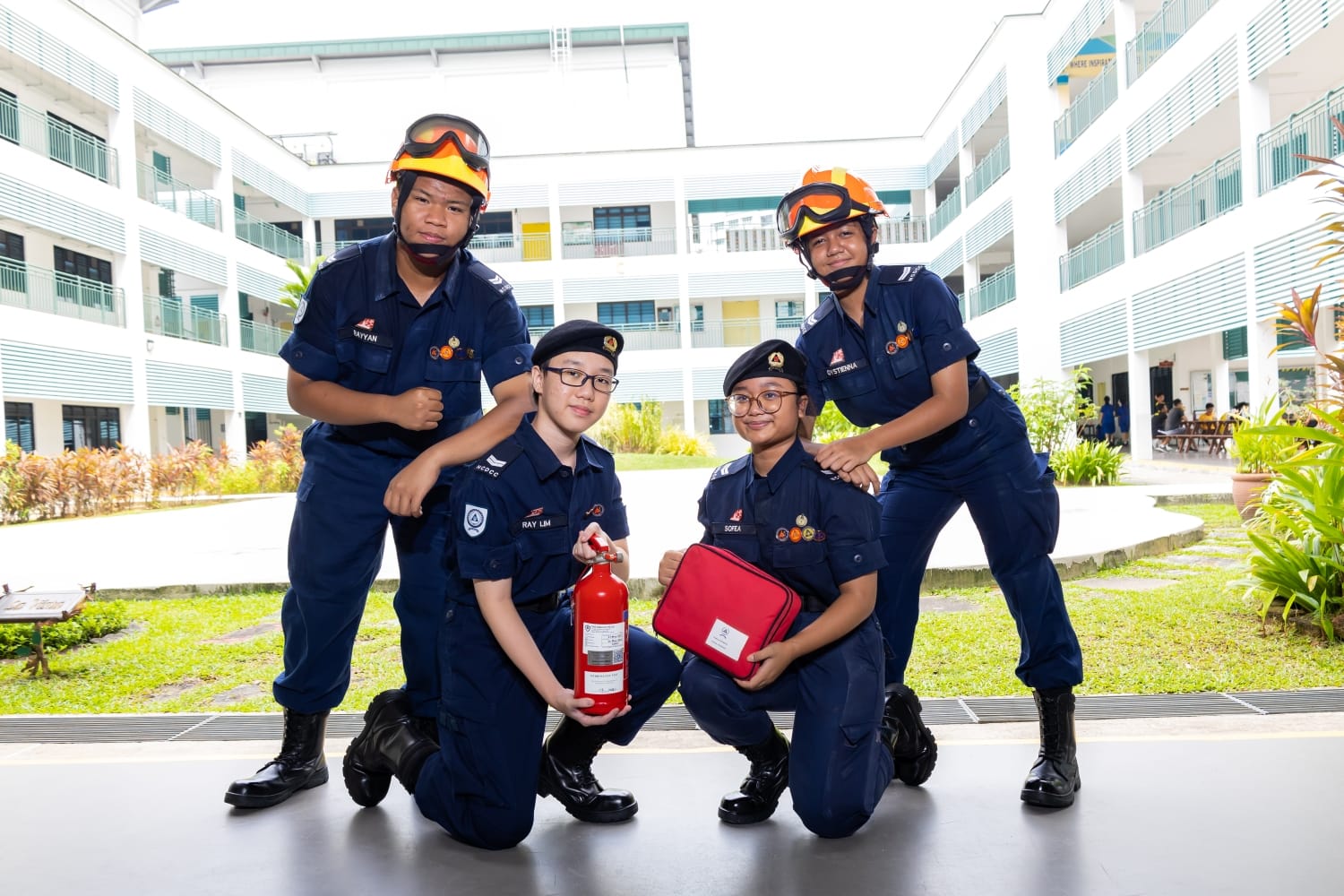 Four students posing with their NCDCC uniform, helmet and equipment