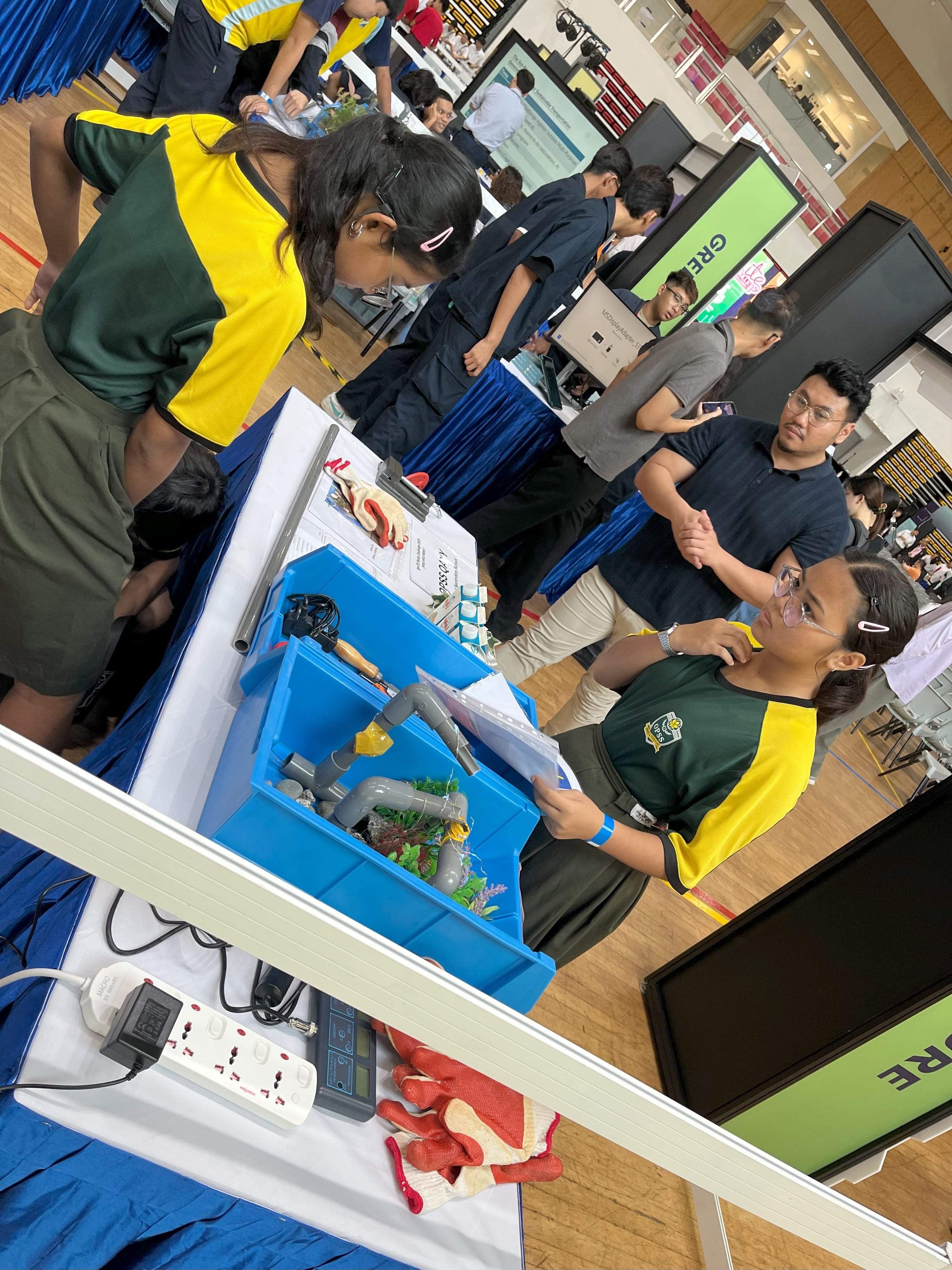 2 students on opposite sides of the table discussing their project setup