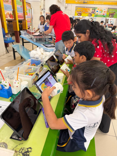 Students independently explore Sony Creative Toy ideas during recess, using instructional videos to guide them in designing and creating their own simple toys.