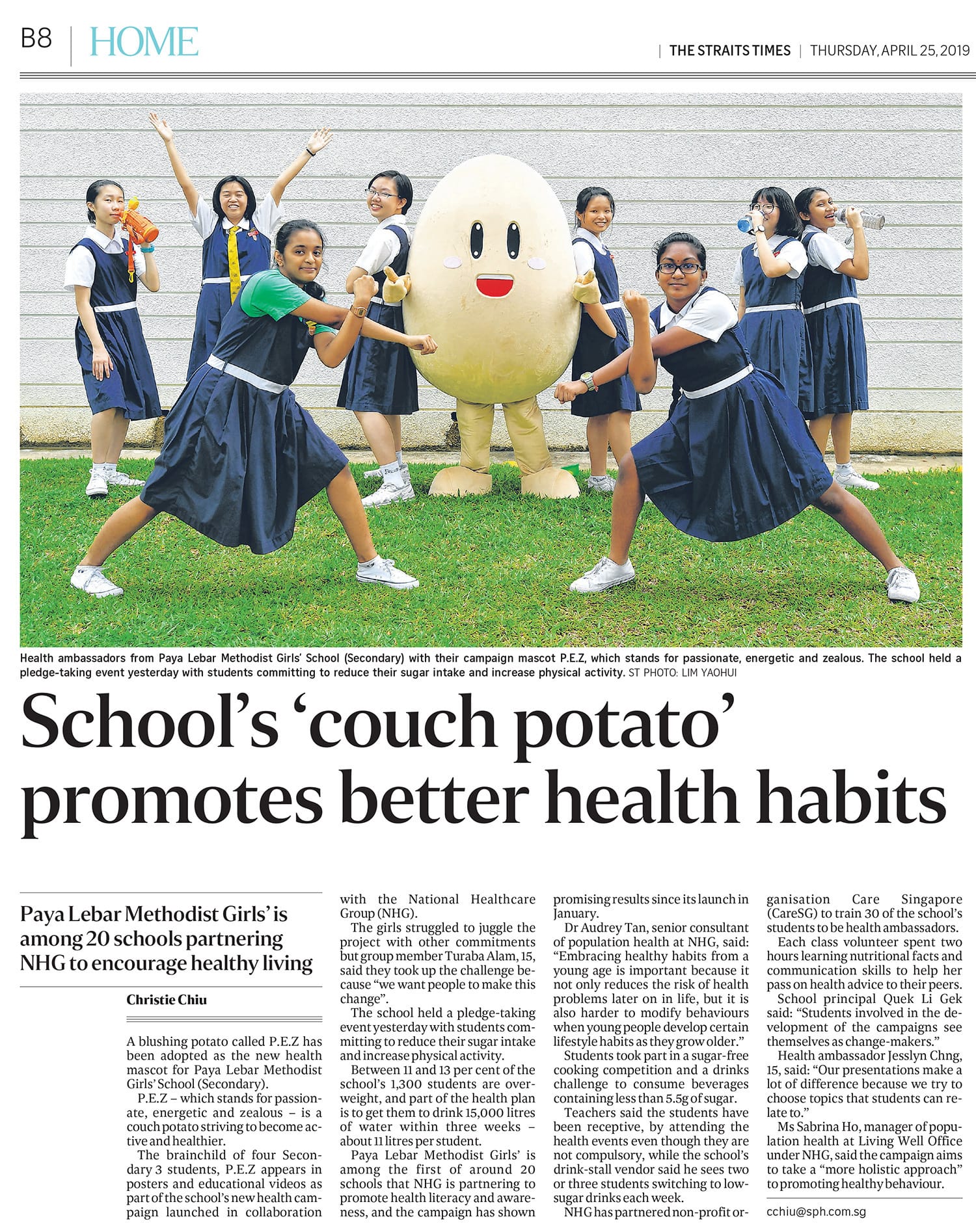 Straits Times newspaper article with schoolgirls in uniforms posing with a smiling potato mascot on grass.