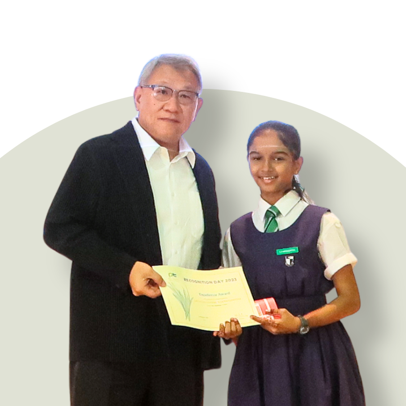 Gayathri receiving an award certificate from an official during a presentation ceremony