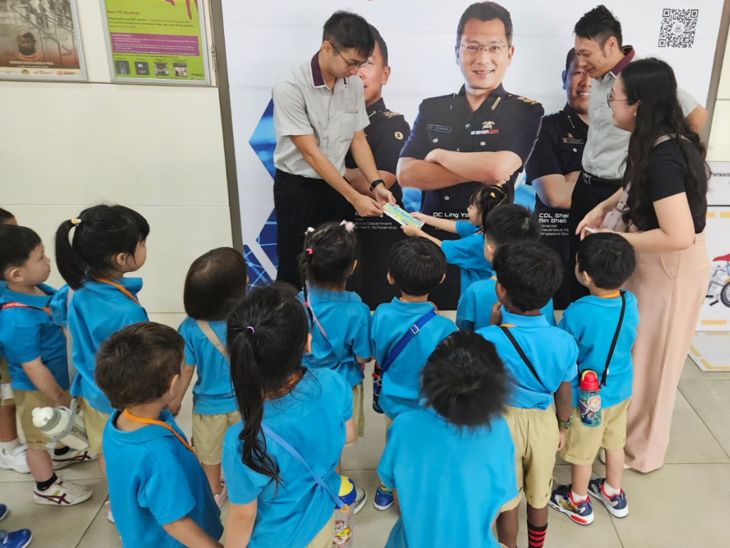 Children present their questions and interact with community members during a learning journey, gaining real-world knowledge through inquiry.