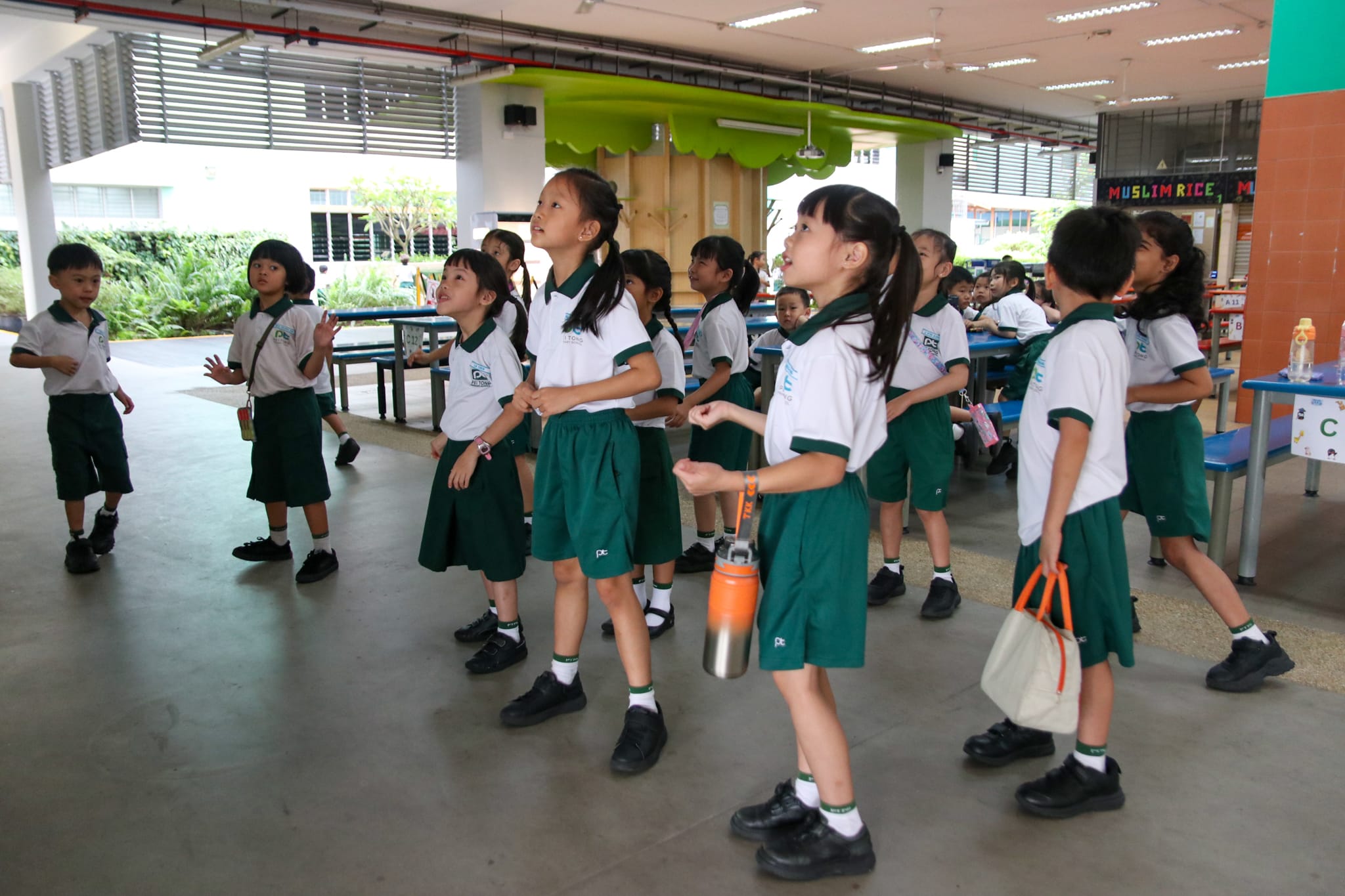 Students enjoying a lively Hari Raya sing-along and dance session during recess, fostering cultural appreciation and community spirit