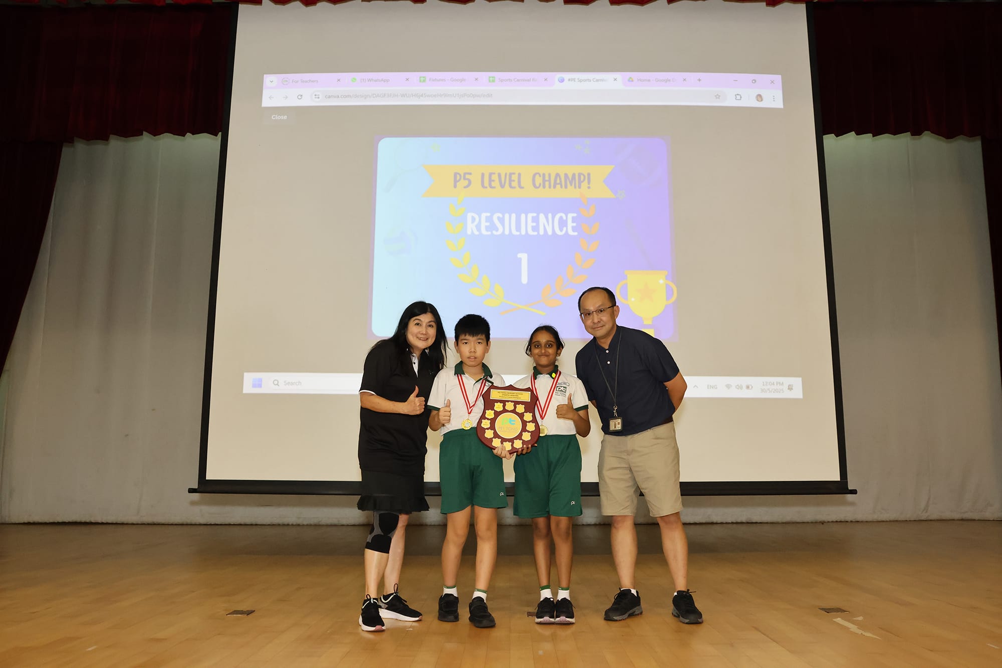 Student representatives receive the P5 Level Champion trophy for Team Resilience on stage alongside teachers during the Sports Carnival prize presentation.