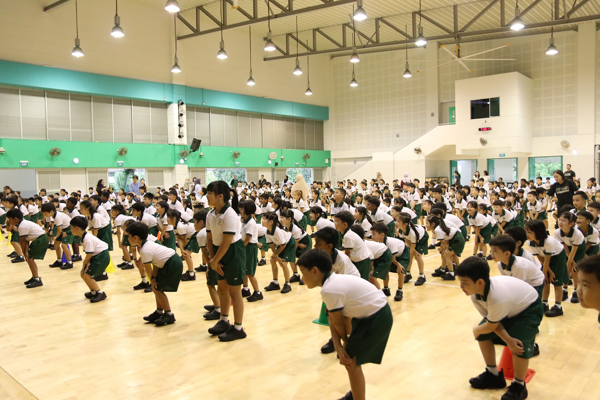 Primary 1 and Primary 2 students participate in a mass dance session, moving together through energetic routines that promote coordination, teamwork, confidence, and enjoyment of physical activity.