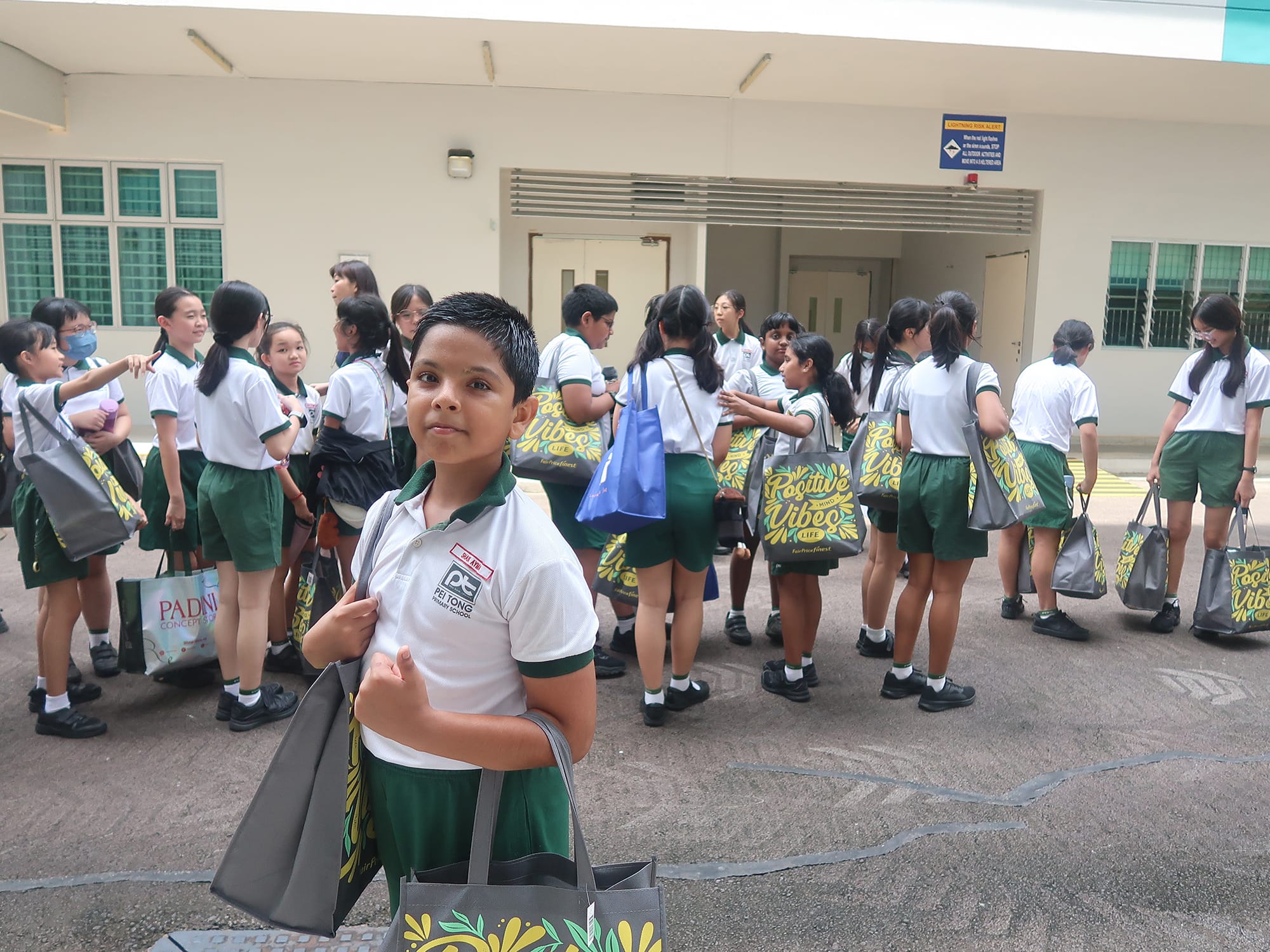Students gather with donated items and packed goodie bags before distributing them to seniors as part of a community service project.