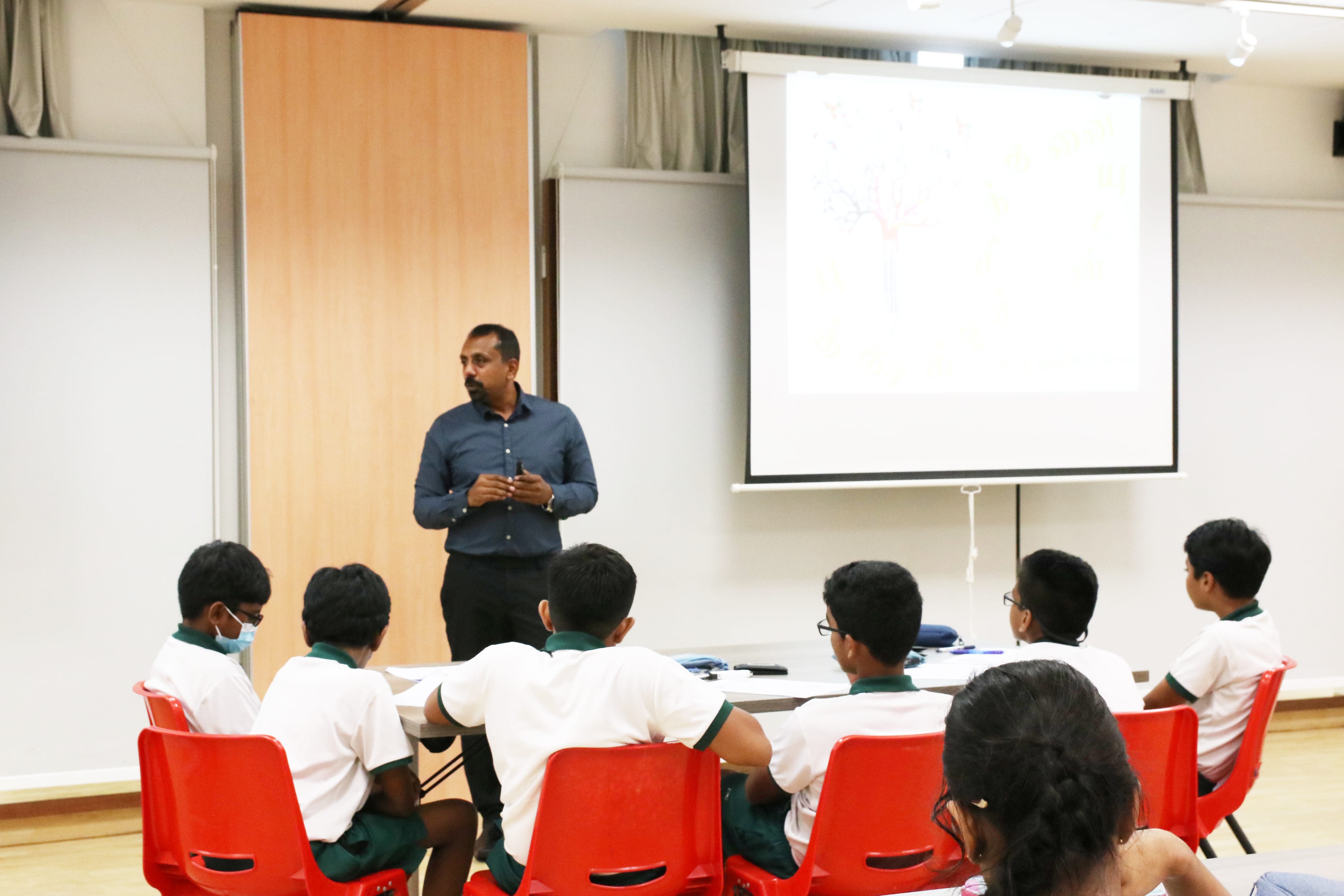 Students engaging in a creative writing workshop, learning techniques for crafting poetry and stories while developing their expressive language skills.