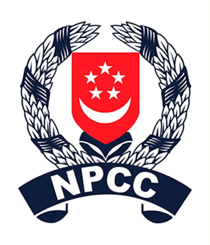 NPCC badge with a red shield showing a crescent and five stars, framed by navy laurel wreaths and a banner.