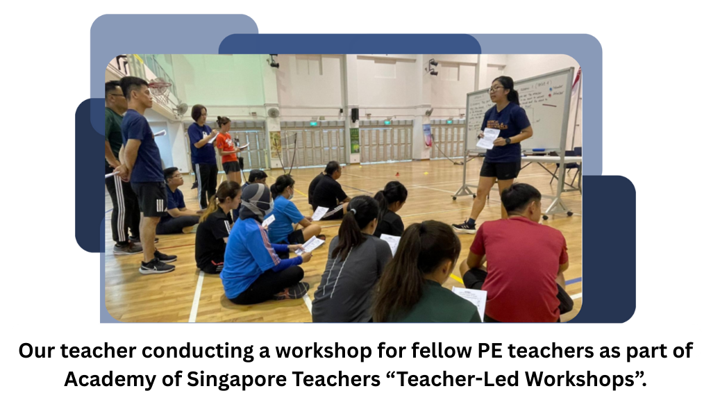 A teacher stands by a whiteboard in a gym presenting to a group of teachers seated on the floor.