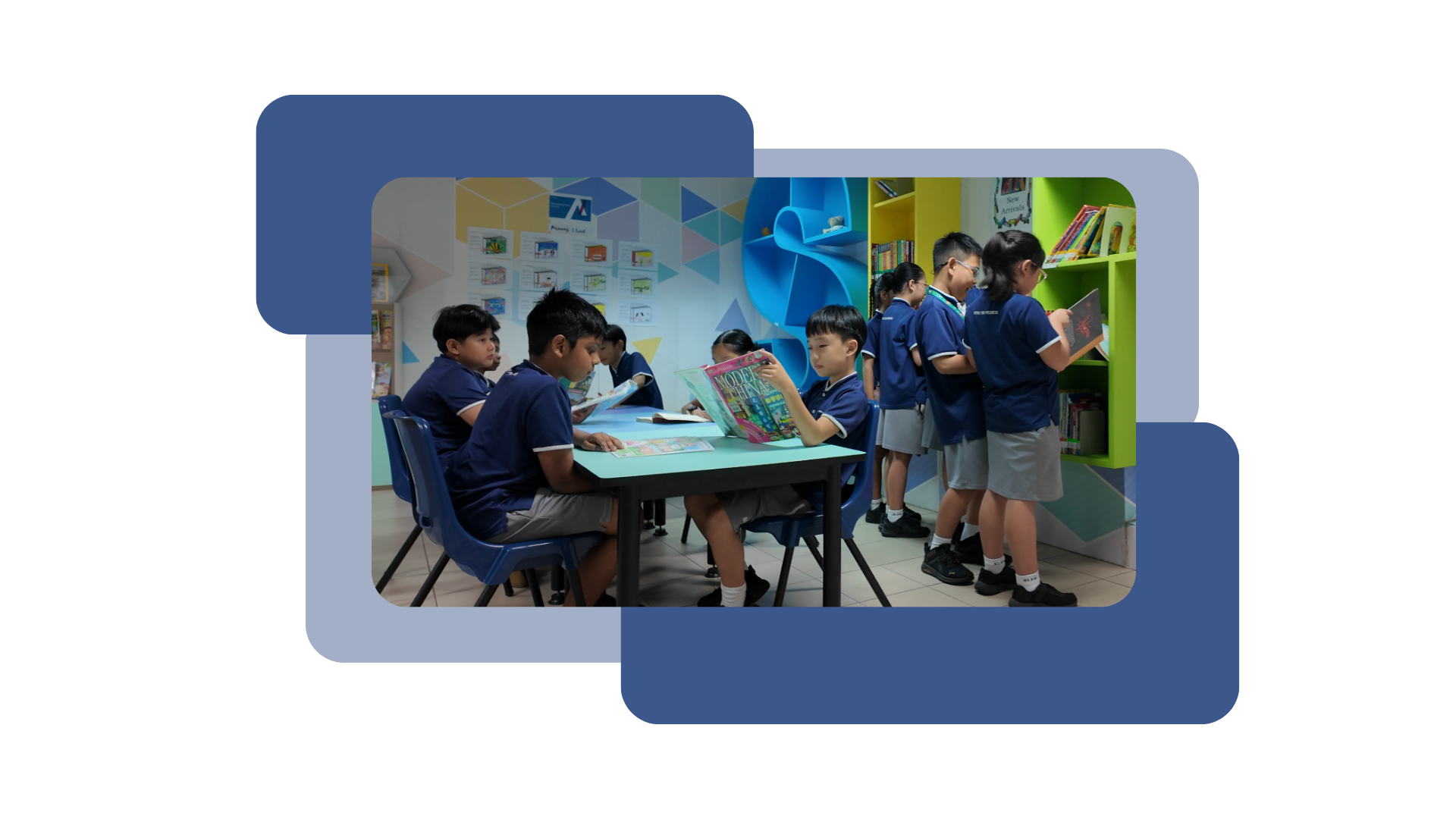 Young students in blue uniforms read books at a table and browse colorful shelves in a school library.