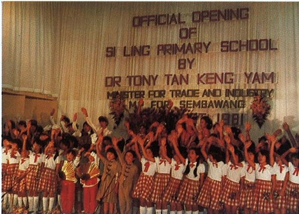 Students and staff celebrating the official opening of the school during a historical ceremony