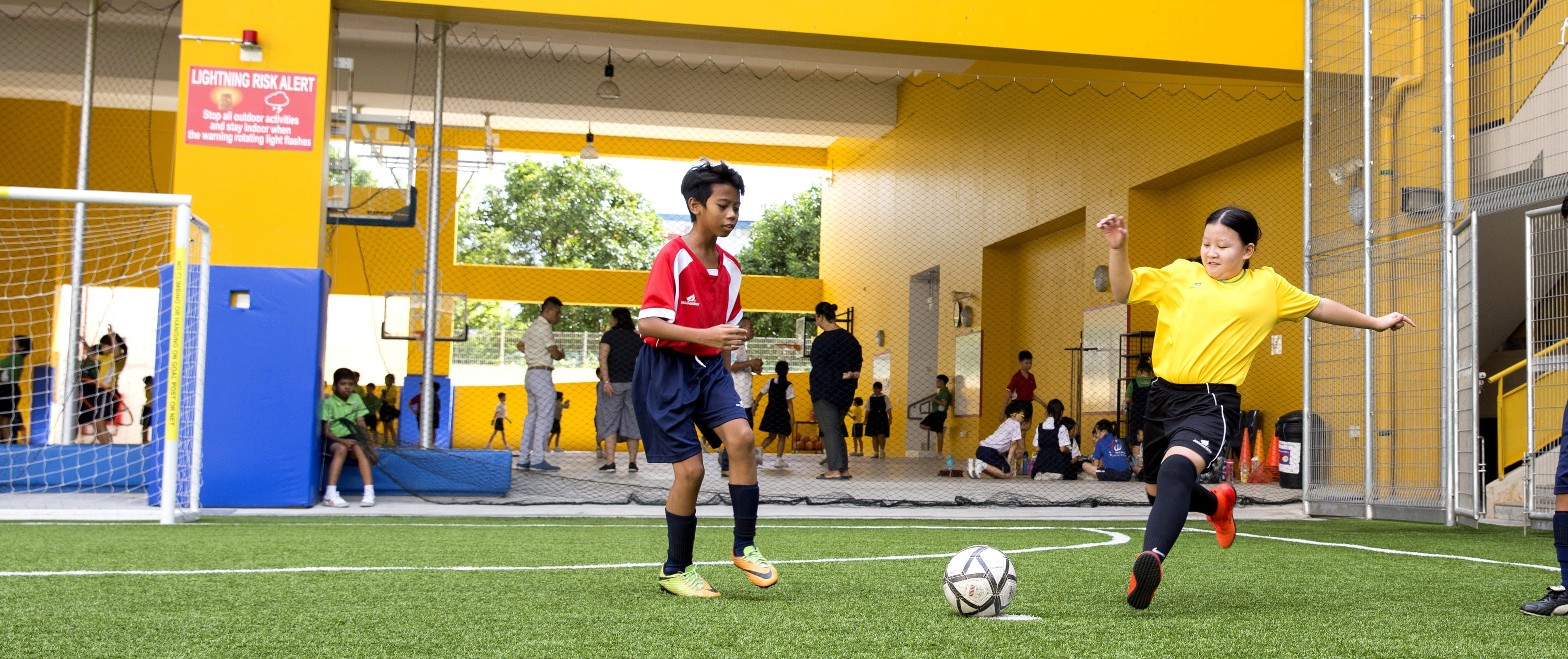 Jermine playing in a school soccer match, demonstrating confidence and passion for sports.