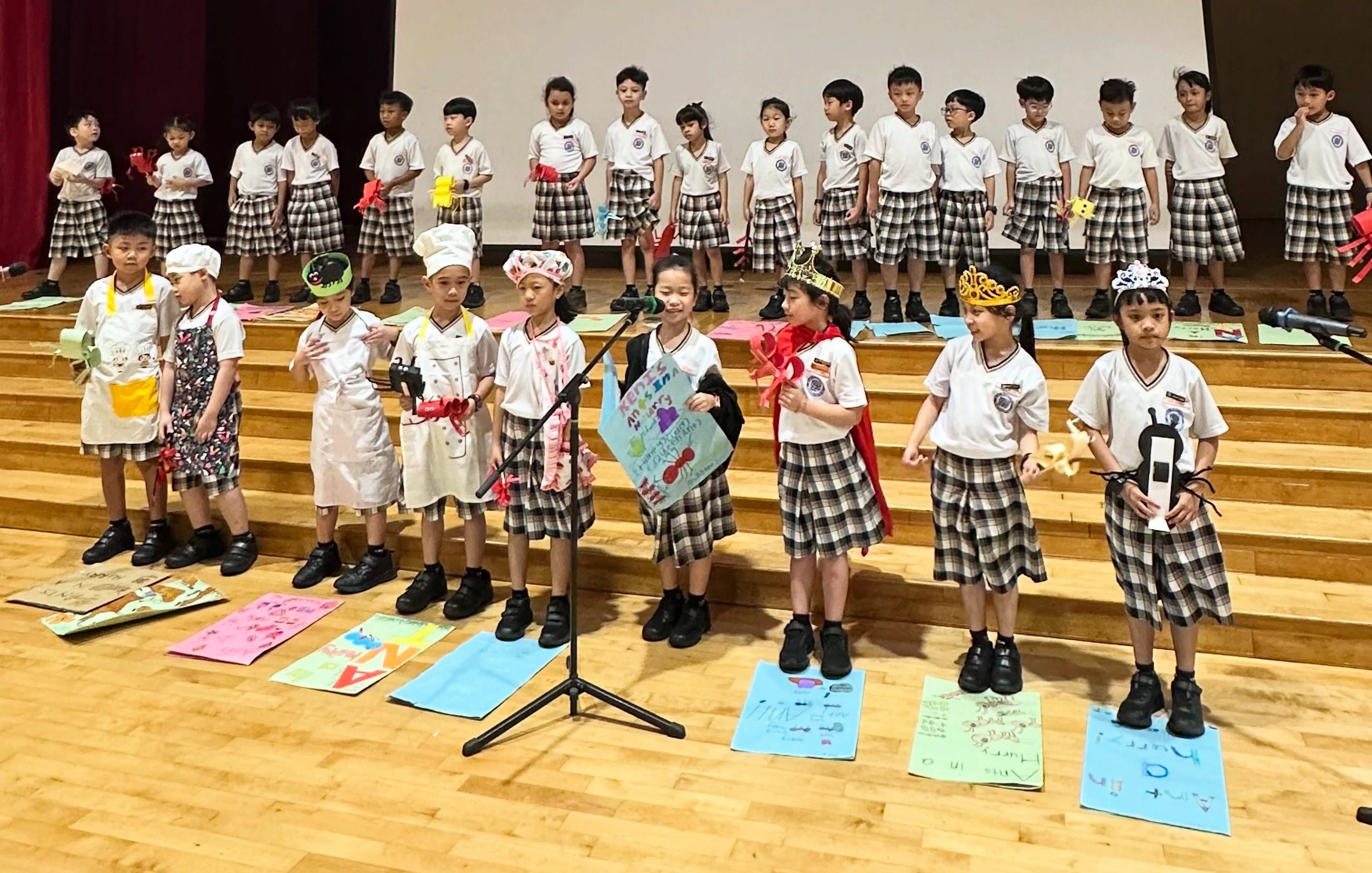 Lower-primary students performing on stage in costumes during the Celebration of Learning.