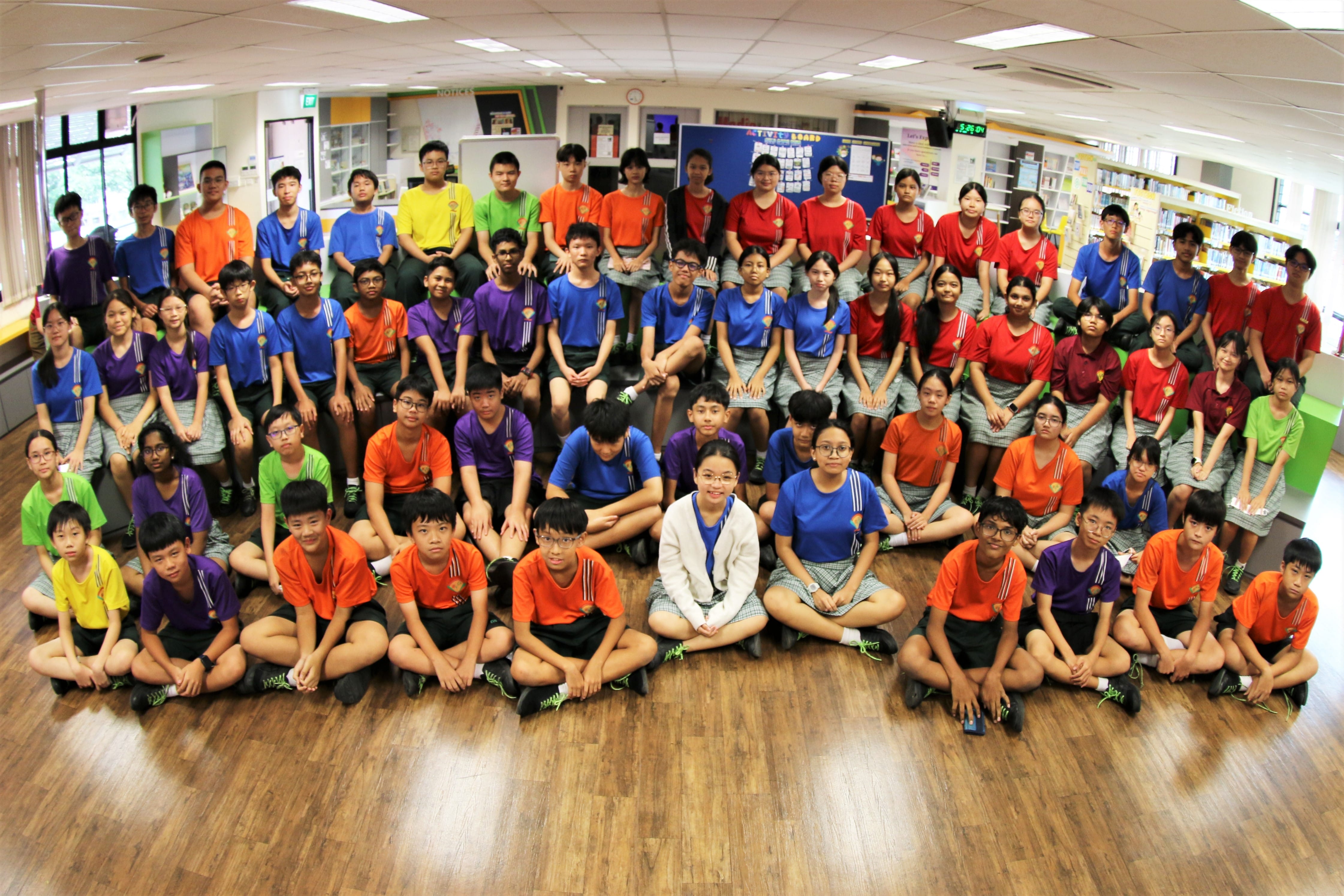 DMC members posing for a photo inside a library.