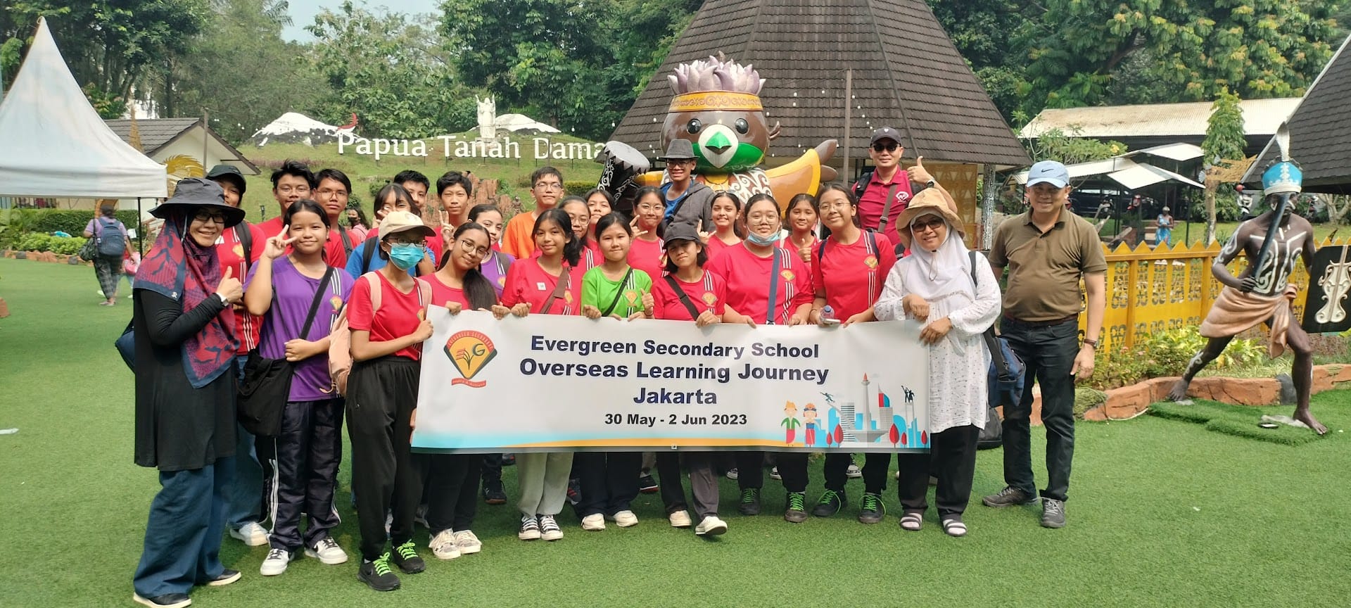 Group of students and teachers holding a banner reading Evergreen Secondary School Overseas Learning Journey Jakarta 2023.