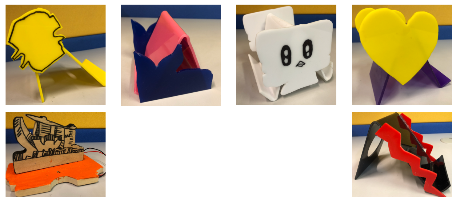 Six colorful 3D-printed and laser-cut small sculptures including a heart, a cute face, and zigzag shapes.