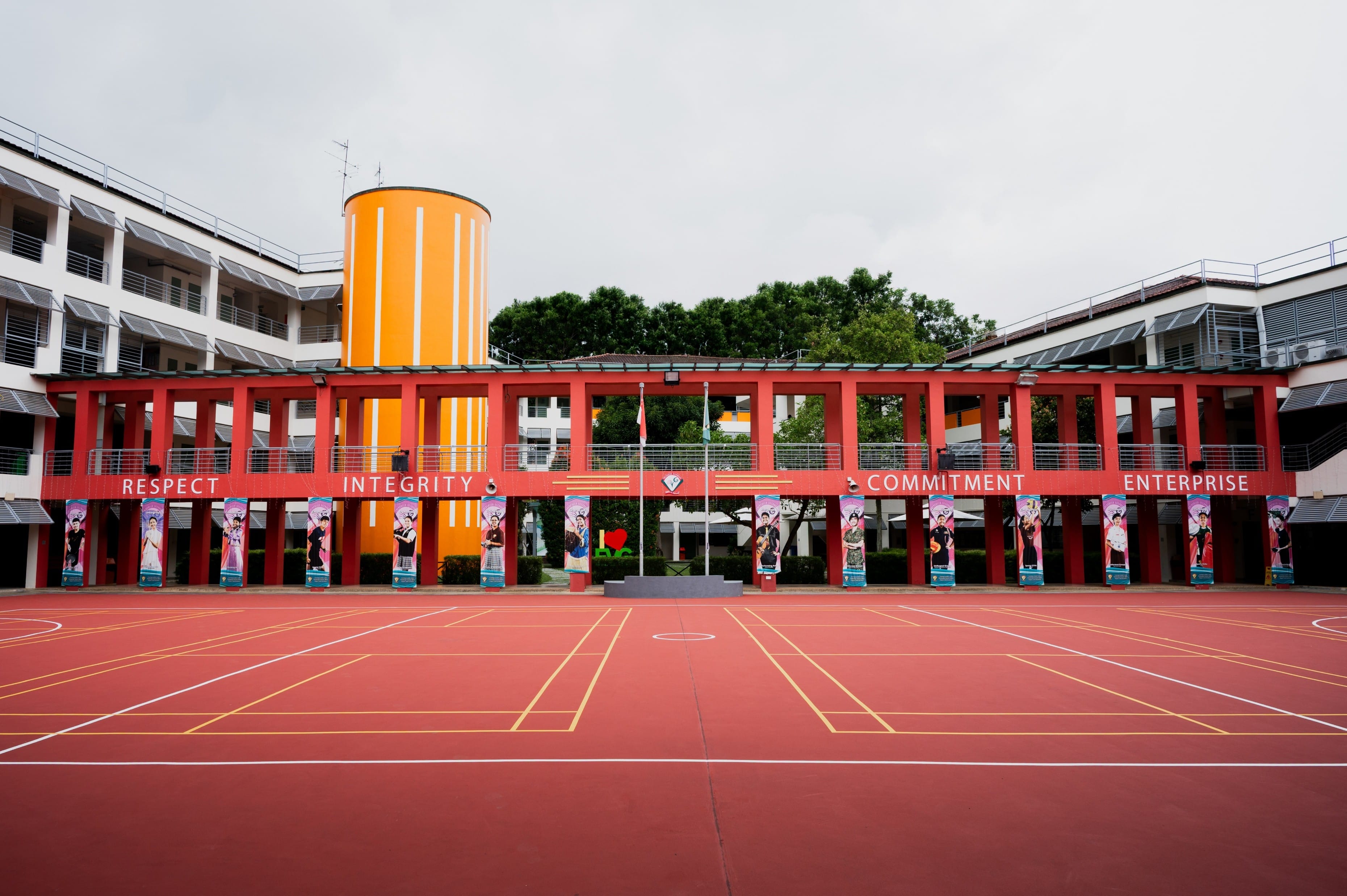 School parade square with pillars displaying "Respect Integrity Commitment Enterprise".