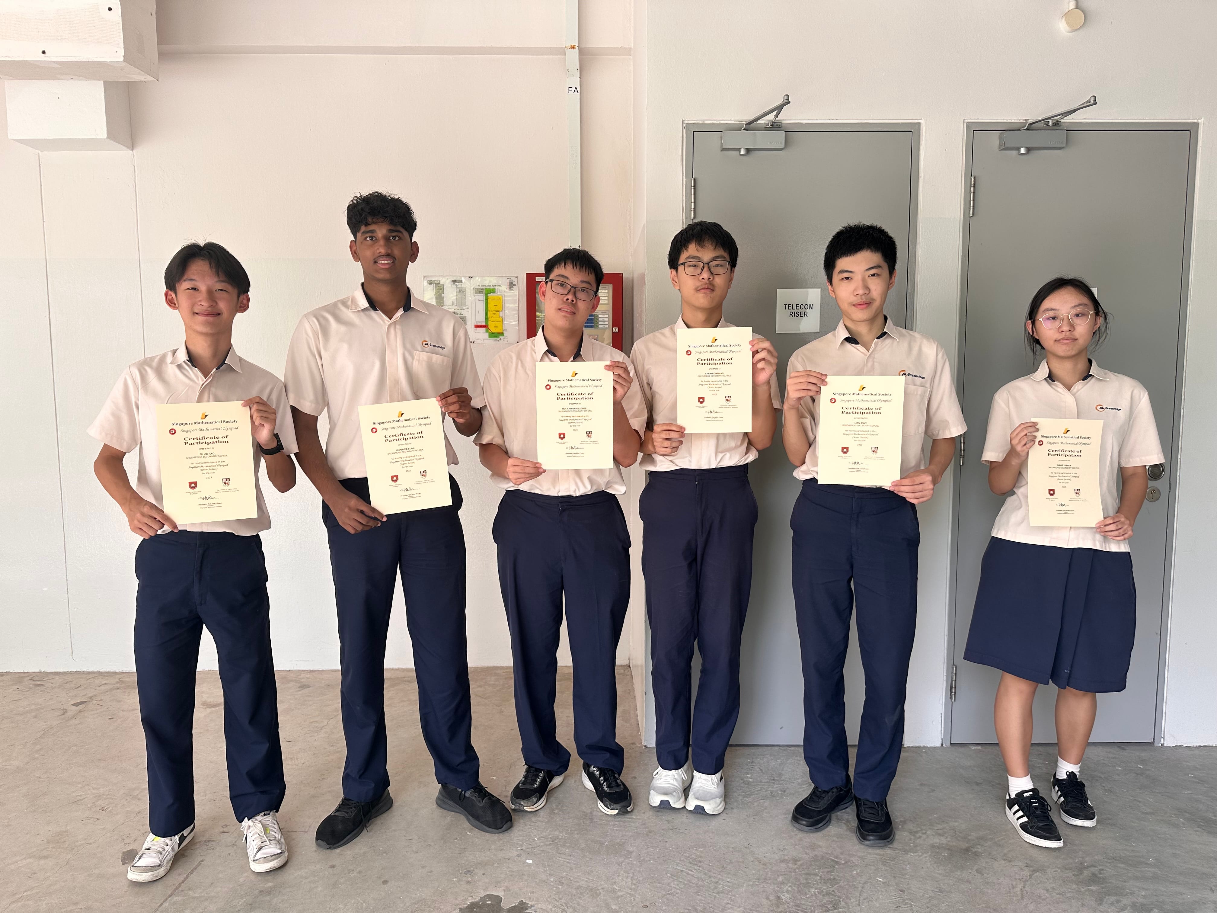 Six uniformed students stand together holding Certificates of Participation from the Singapore Mathematical Society.