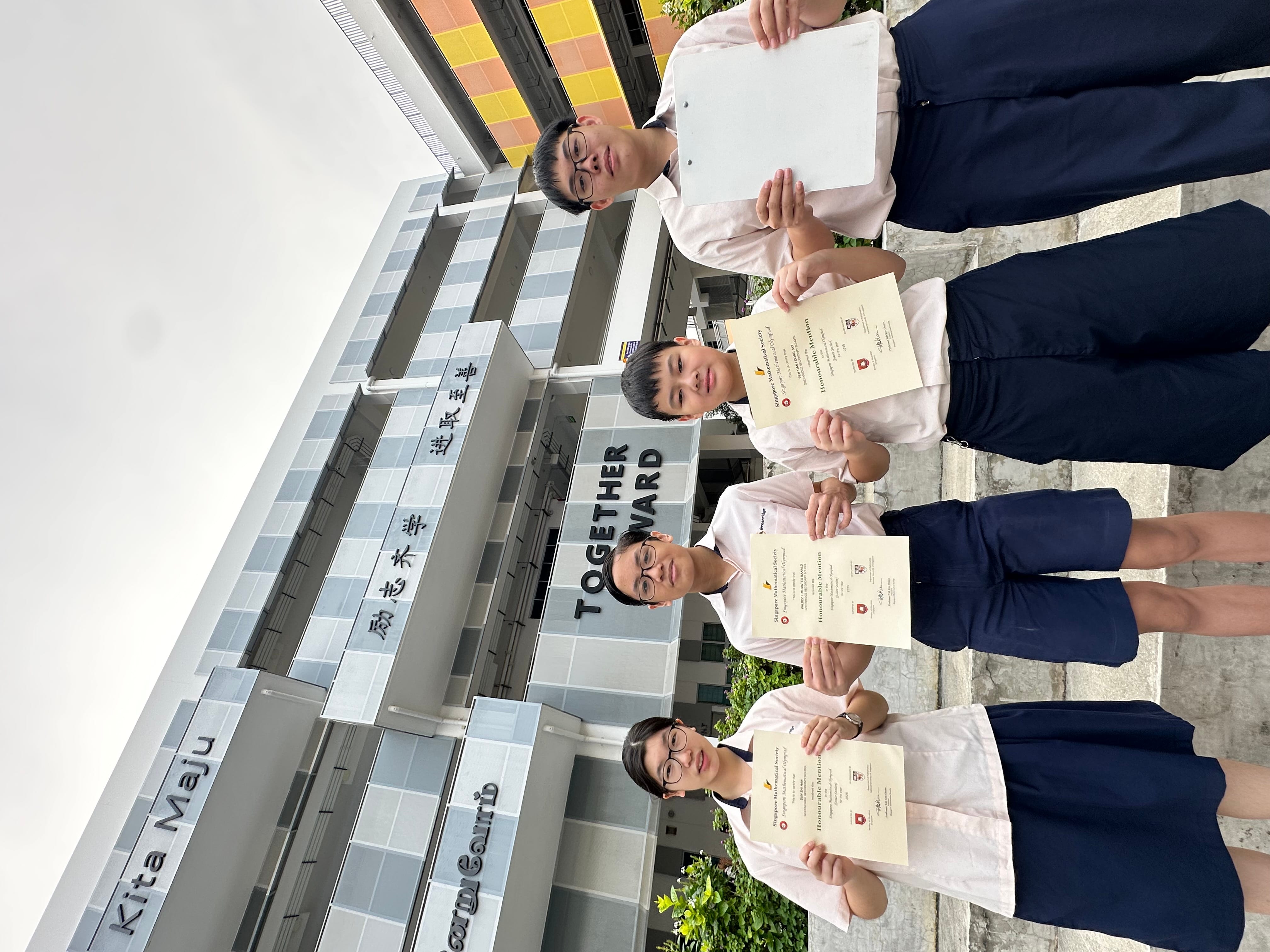 Four students in school uniforms hold Honourable Mention certificates in front of a building reading "Together Forward."