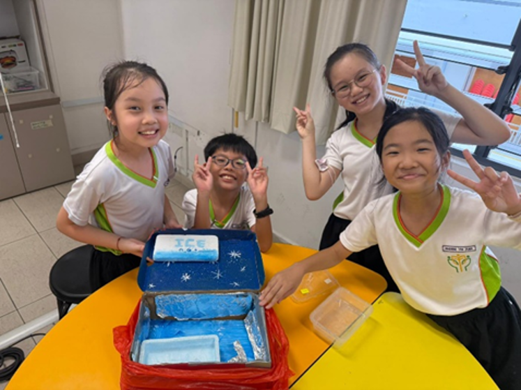 Proud Primary 4 students showcase their completed Super Cooler Box prototypes
