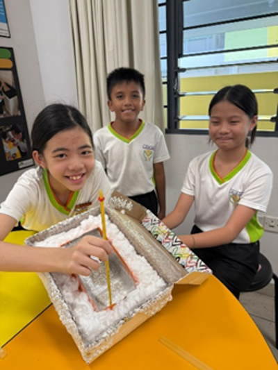 Primary 4 students collaborate to construct their Super Cooler Box prototypes