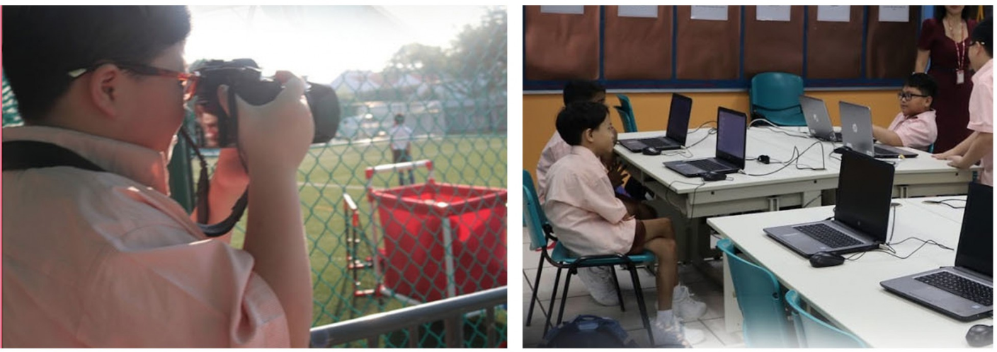 A student photographs a sports field while others work on laptops in a classroom setting.