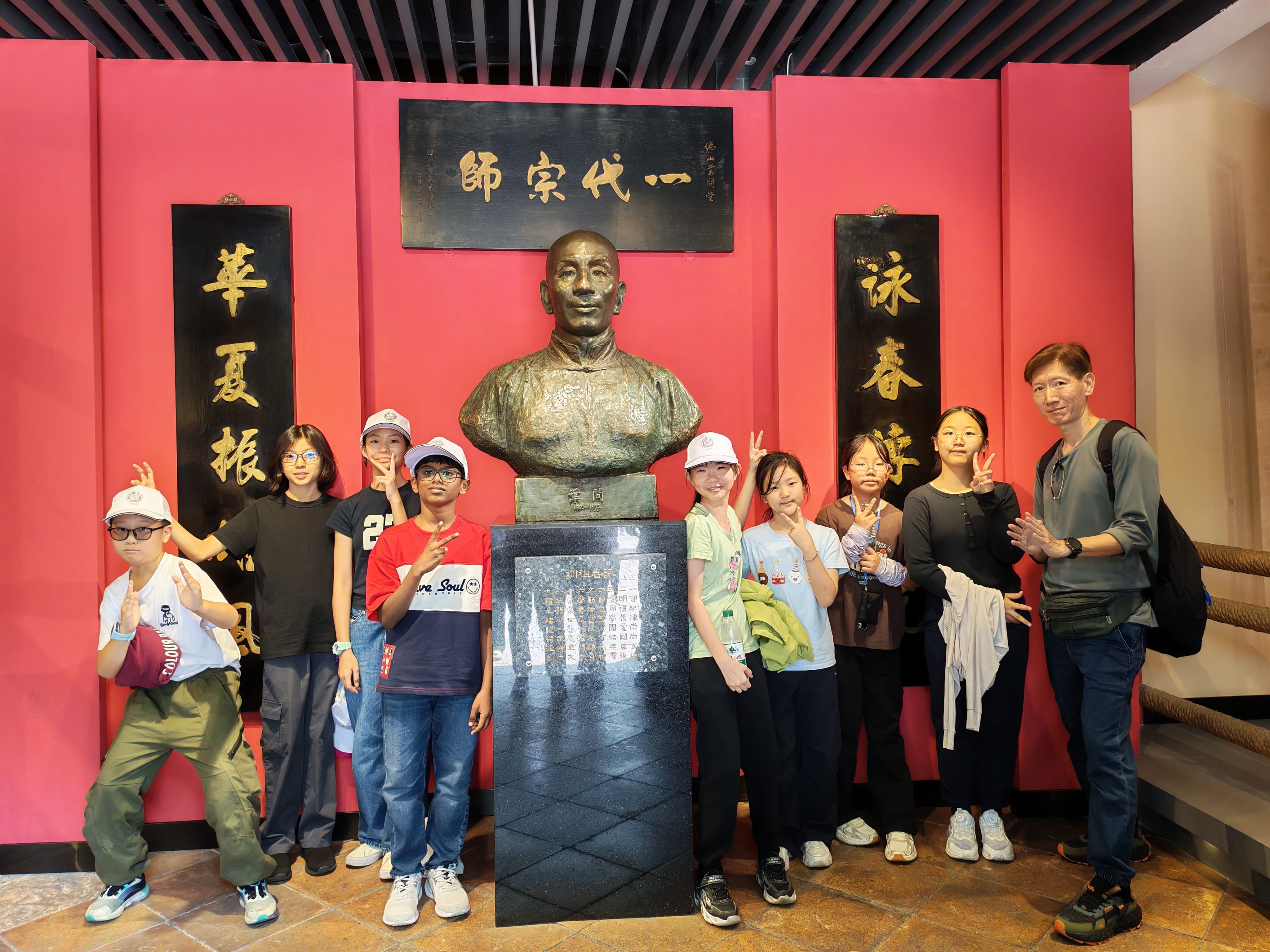 Students posing at a historical exhibit.