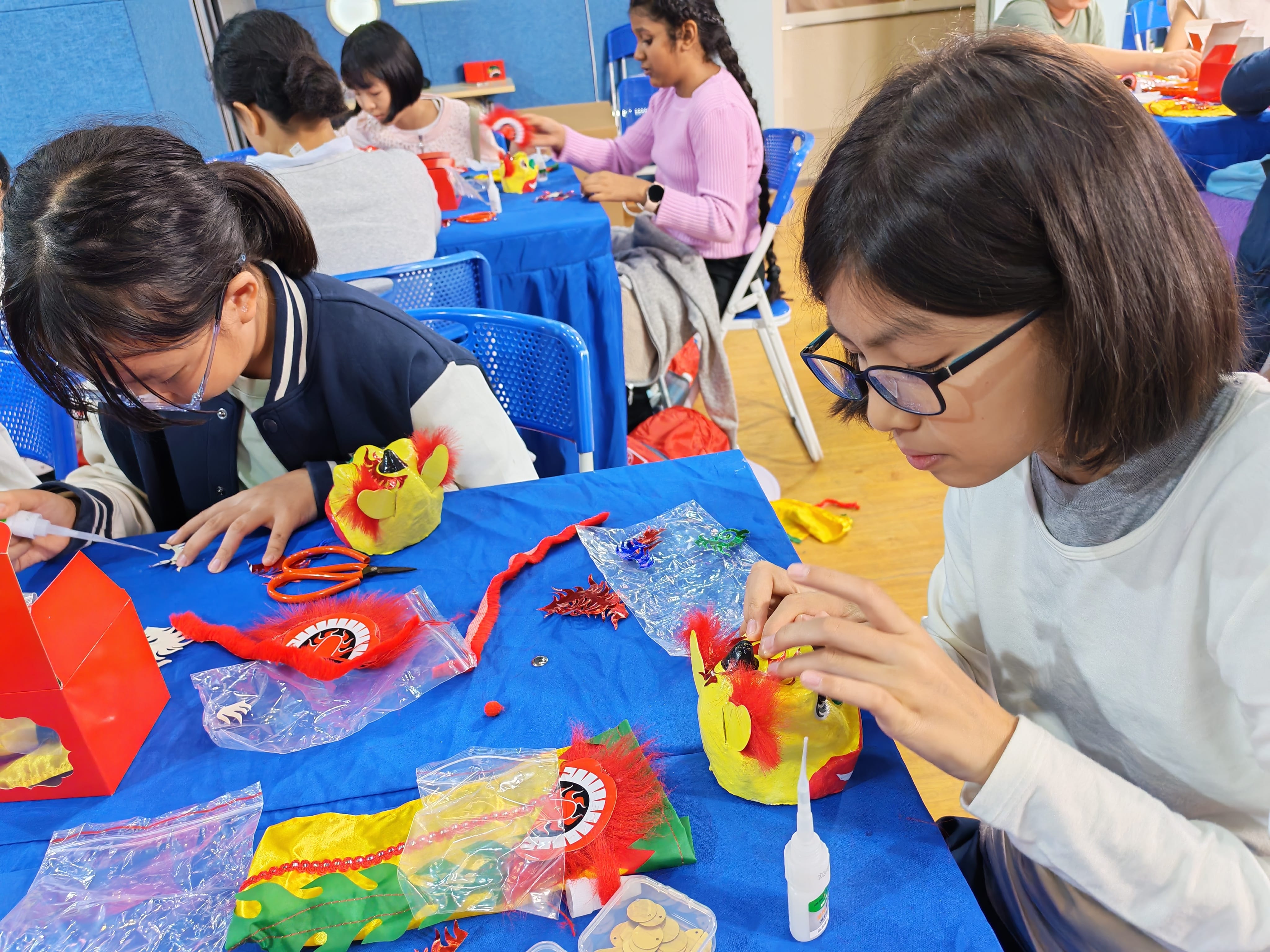 Students making colourful craft pieces.