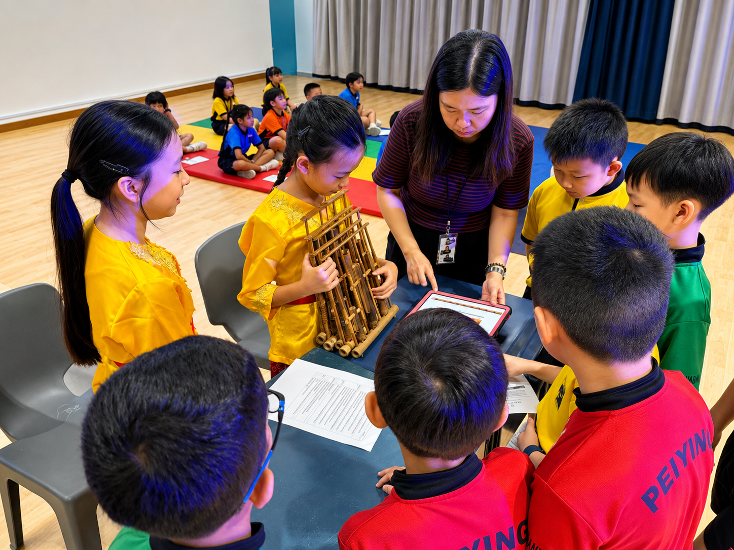 A teacher and students leaning over a table to work on a task.