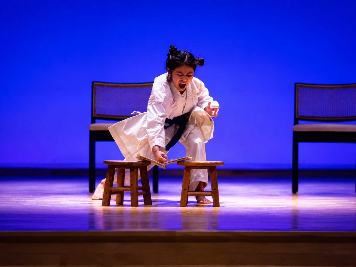 Student acting in a classroom-themed stage scene.