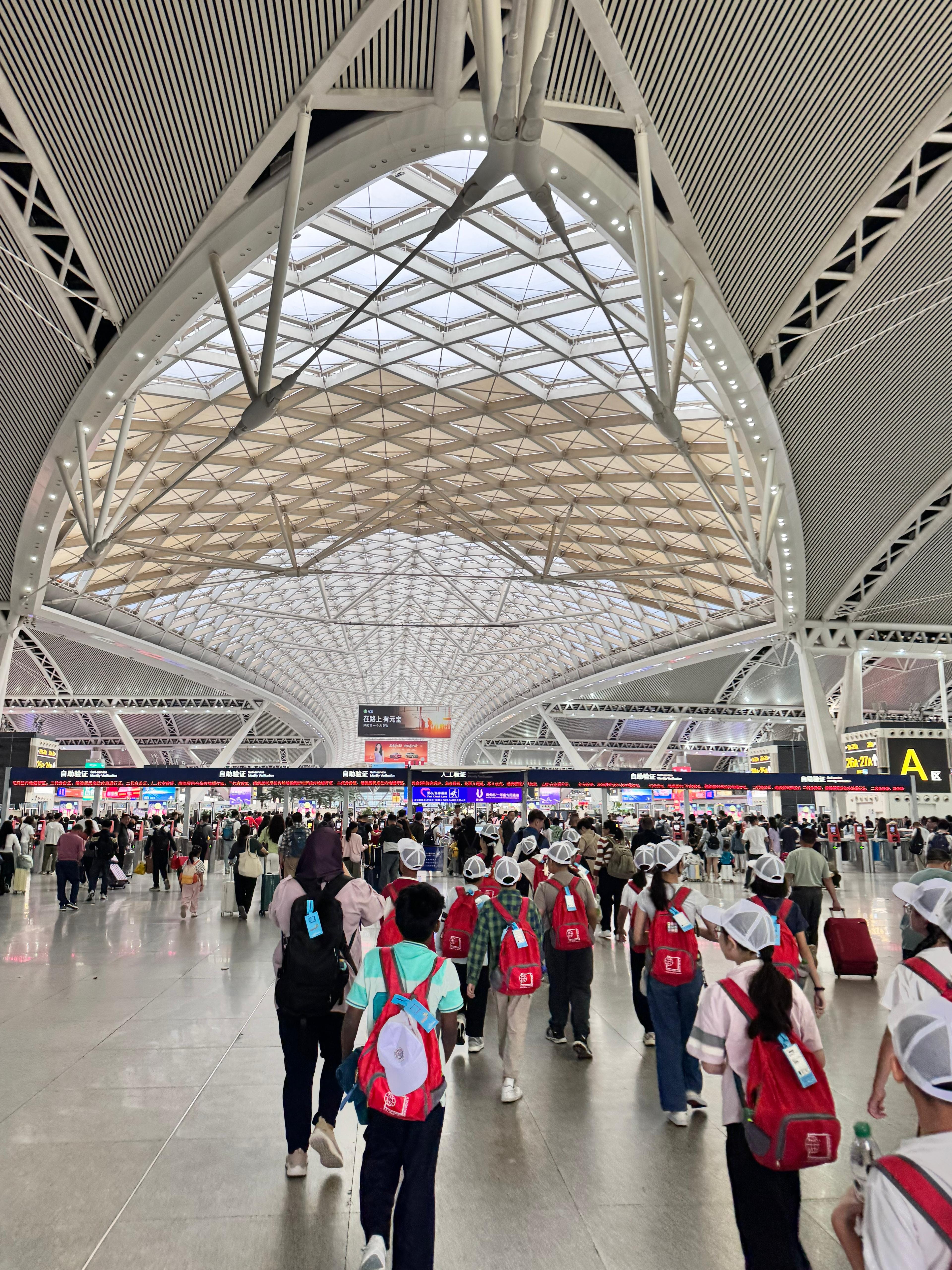Students visiting a busy train station.