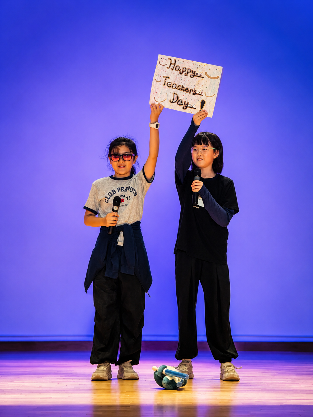 Students presenting during a stage performance.